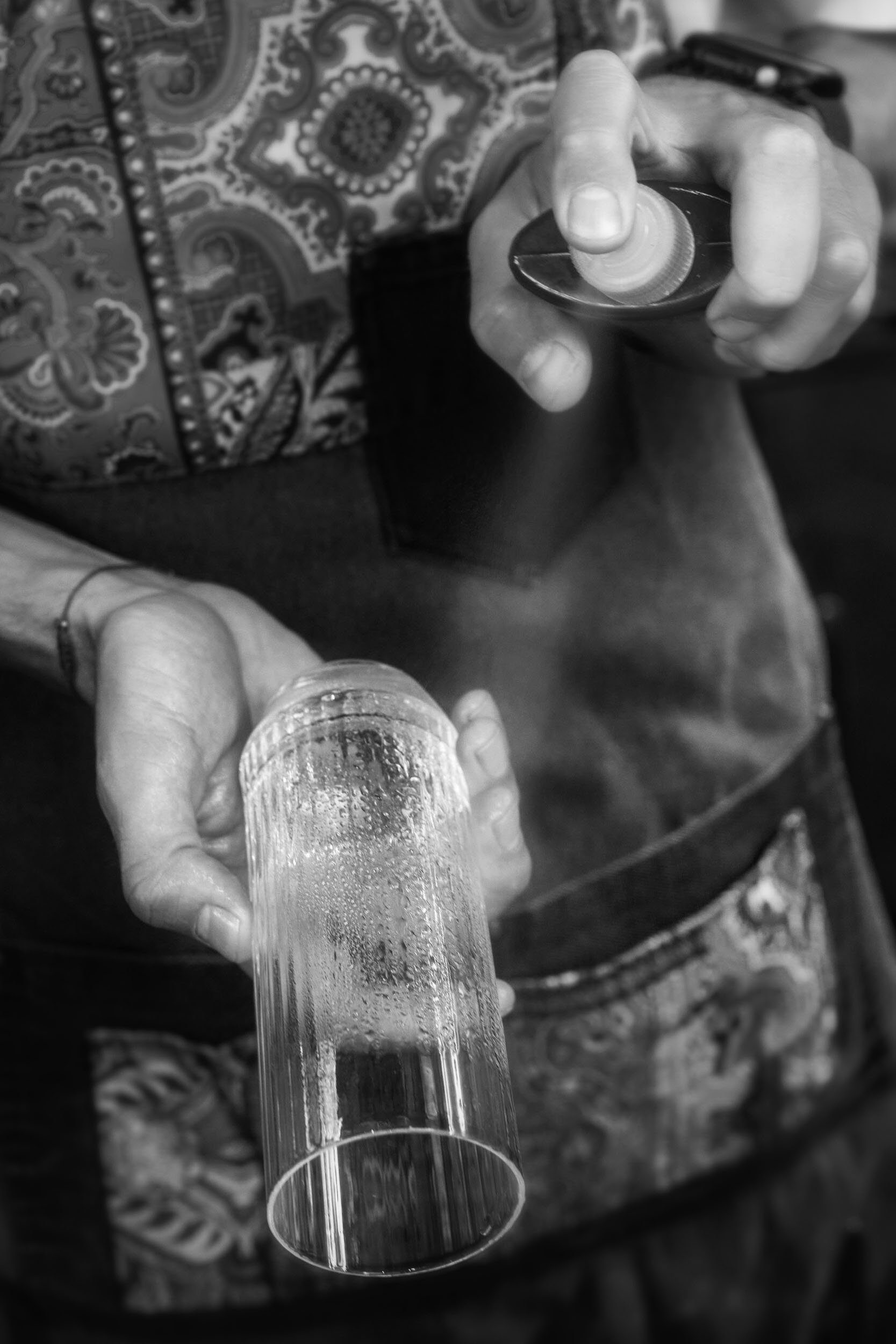 Professional lifestyle photography for a commercial food & beverage project. The image depicts a bartender preparing a cocktail at Hide and Seek Athens, captured by Stavros Kostakis.