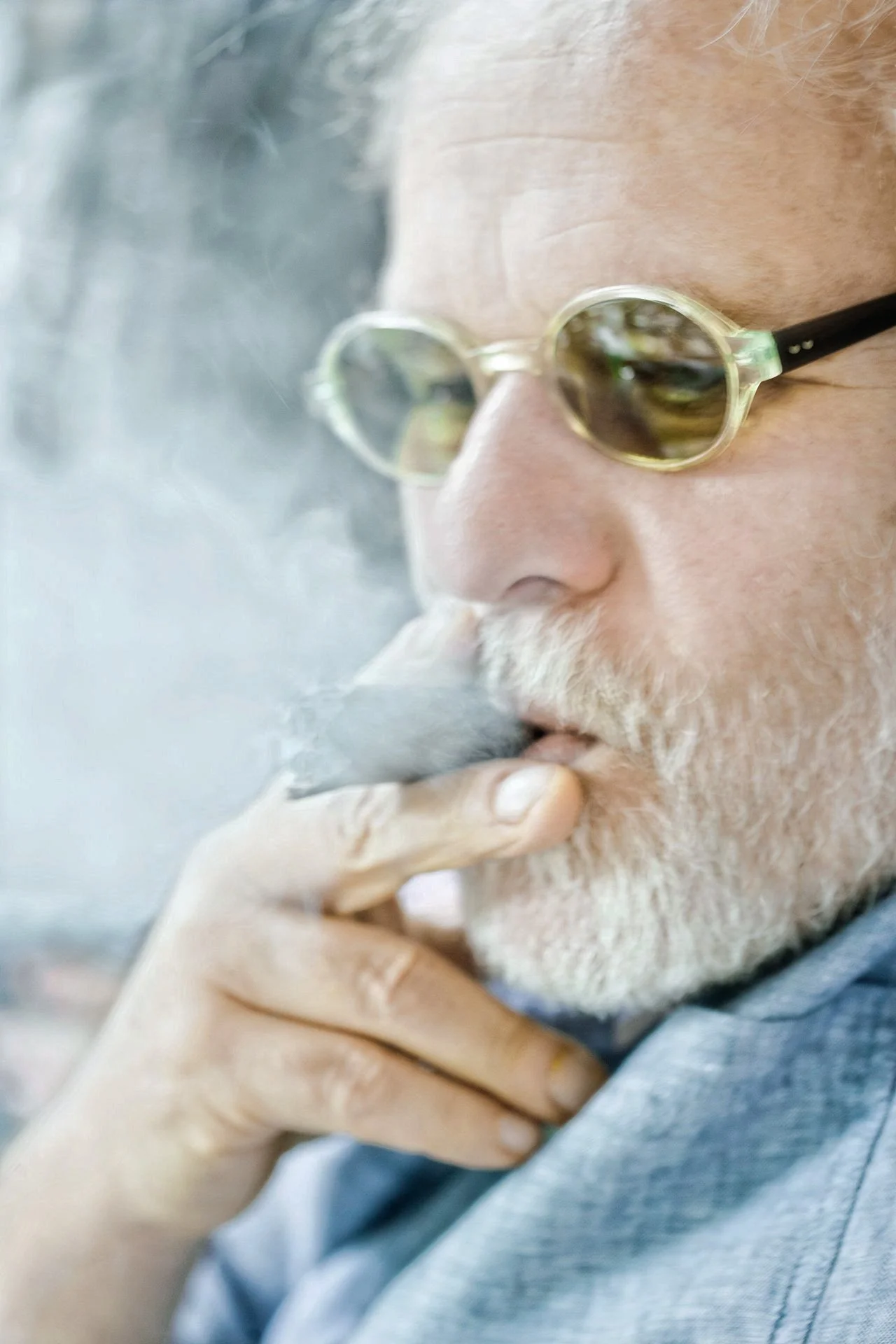 Alvertos Arouch Epikouros | Close-up portrait of Alvertos Arouch (Epikouros), the prominent Greek food critic and author, smoking a cigar in deep thought. Contemporary photography by Stavros Kostakis.