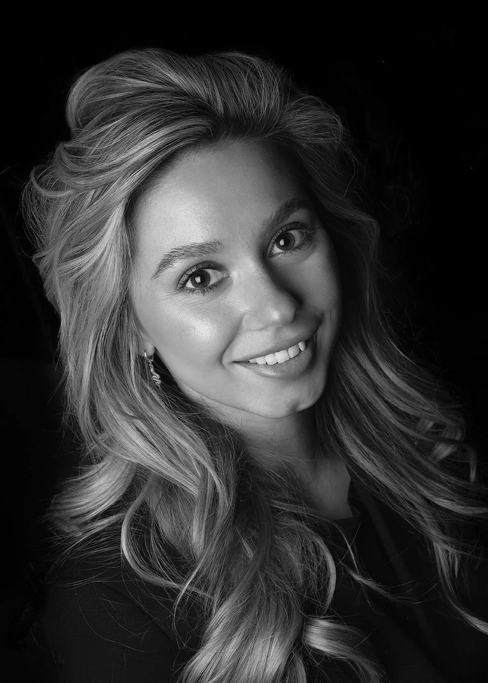 Professional black and white corporate headshot of Lisa Olierook in Rotterdam. The portrait features dramatic, high-contrast lighting that highlights professional confidence and authentic personality. Captured by Stavros Kostakis for executive brandi