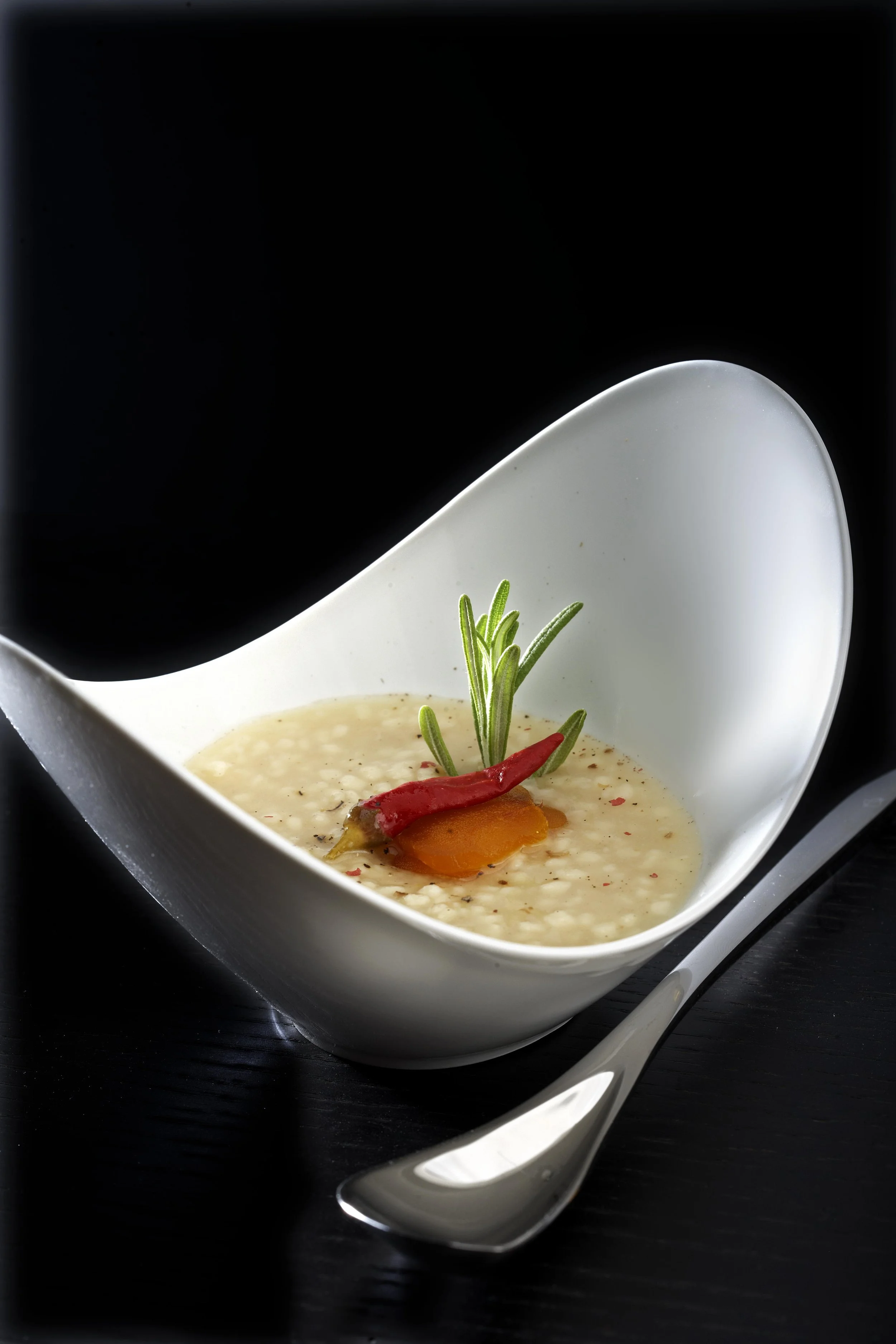 Modern culinary presentation, bottarga risotto gourmet dish, luxury restaurant food styling by Stavros Kostakis Photography.
