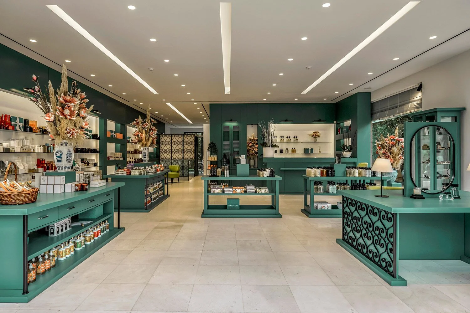 Wide-angle interior photography showing the spatial flow and custom retail shelving by Stavros Kostakis Photography.