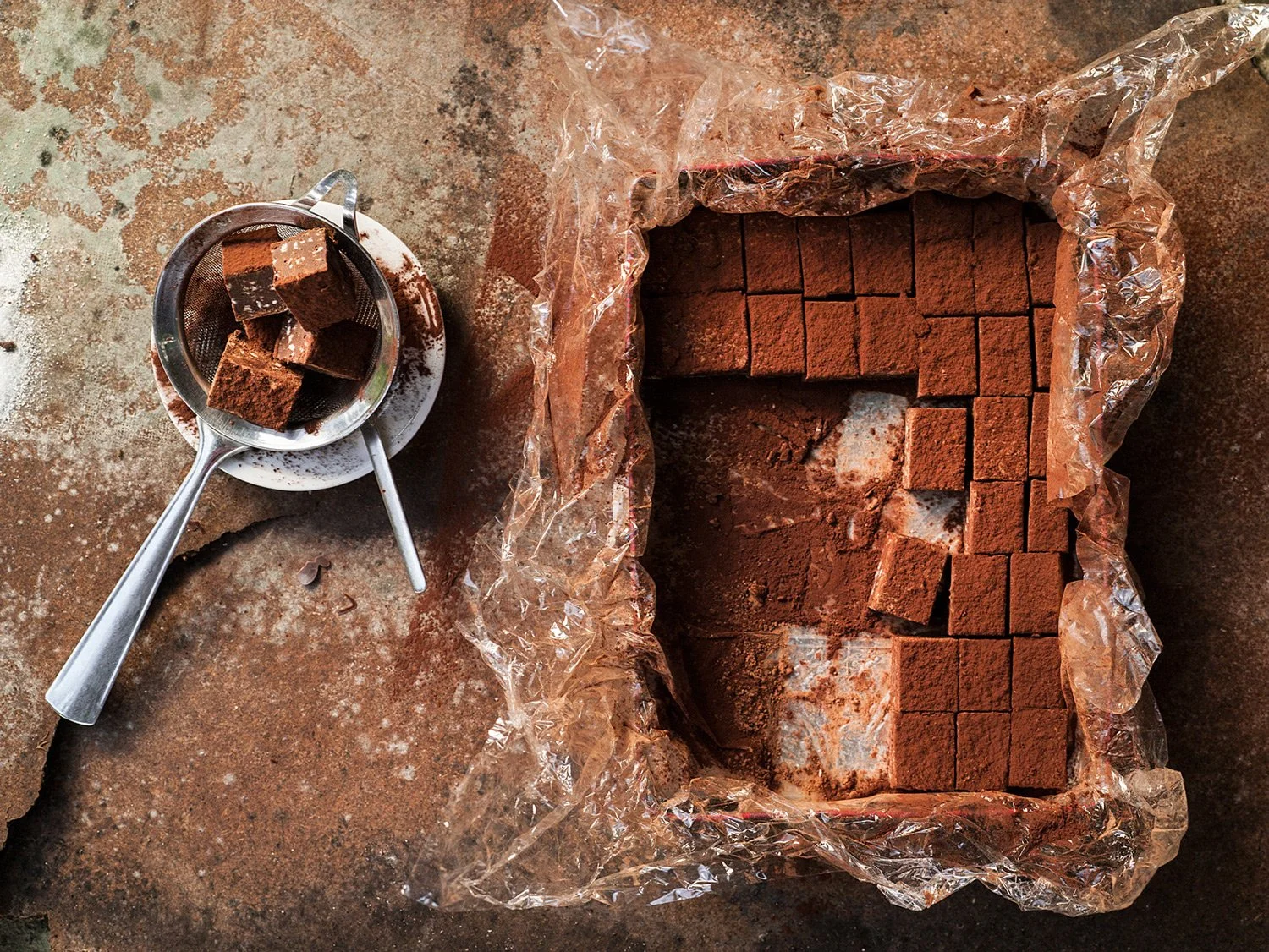 Macro photography of an artisan chocolate truffle cube by Mina Apostolidis, professional food texture assignment by Stavros Kostakis, Belgium.