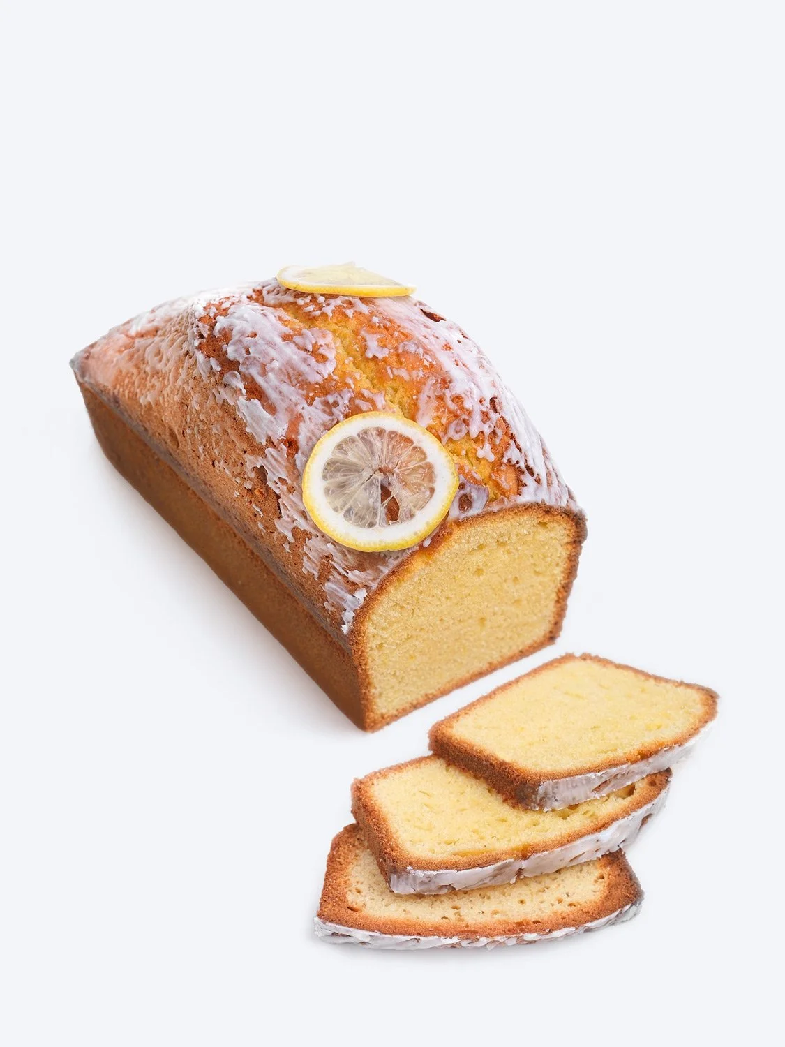 High-quality commercial packshot of a lemon cake for Nikolas Koulepis Patisserie Brussels on a pure white background, professional studio lighting and clean product photography by Stavros Kostakis.