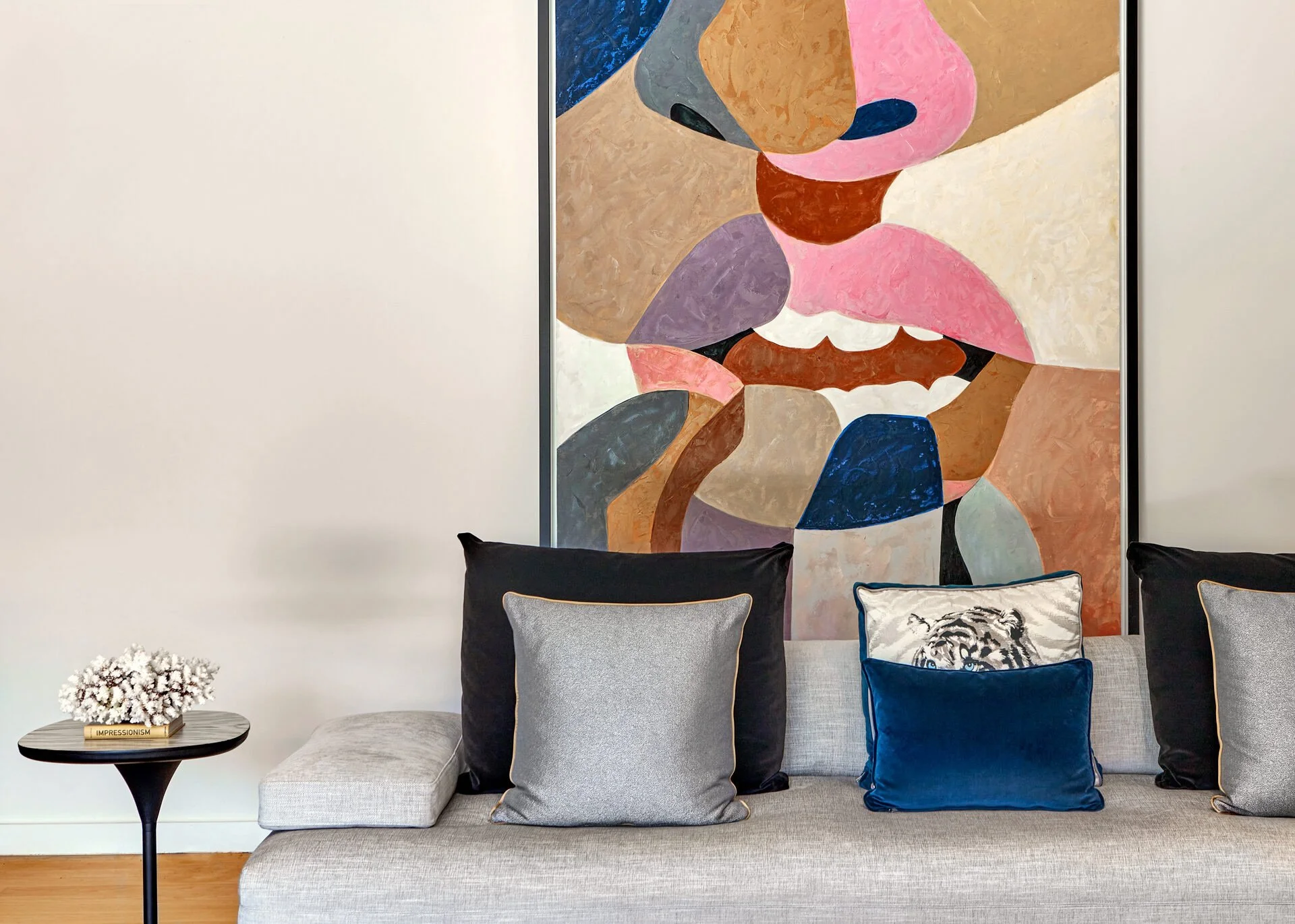 Interior design detail of an Ekali residence by Sissy Feida. Features an abstract painting above a grey sofa with velvet cushions. Photo by Stavros Kostakis.