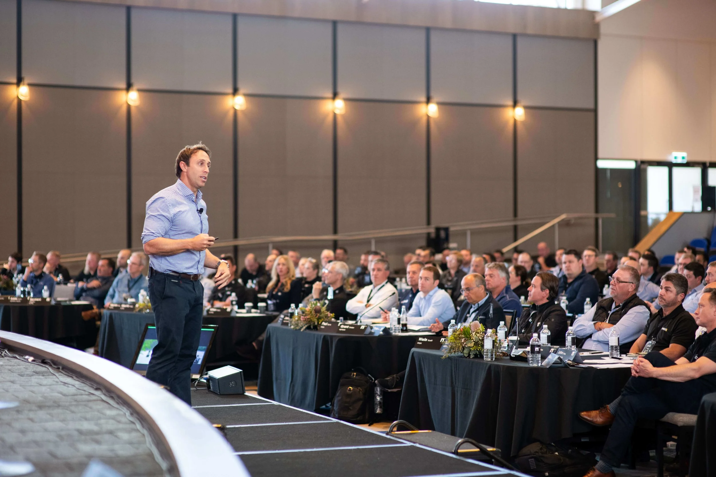 Mark Visser facilitating a corporate workshop event with audience participation and discussion.