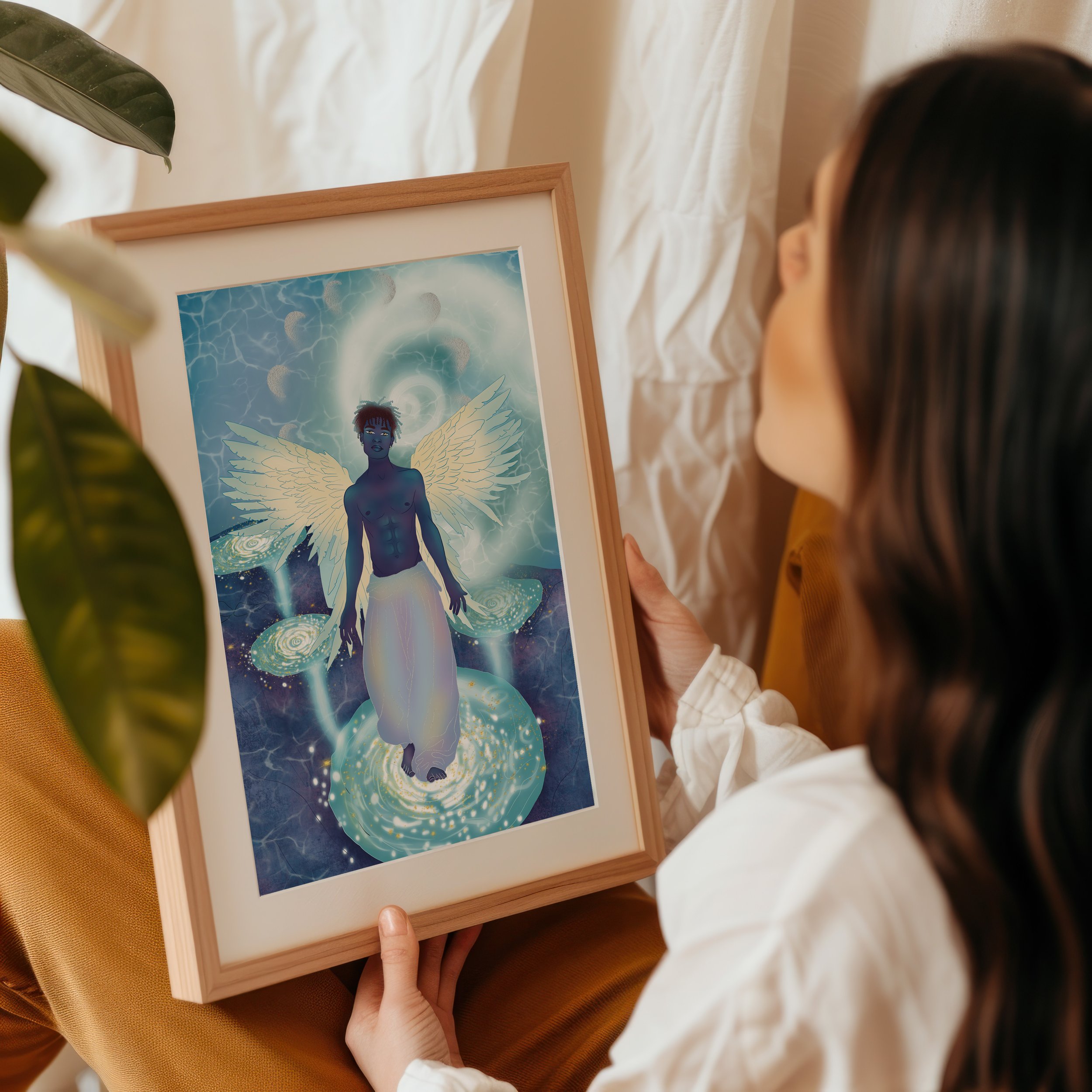 A person with dark hair holding a framed artwork of a fantasy character with blue skin, wings, and a cosmic background.