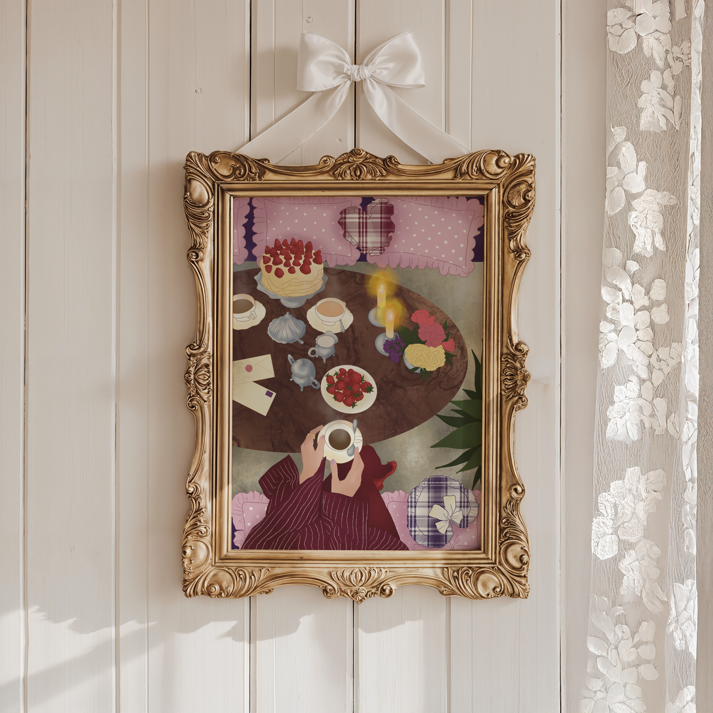 This image shows a decorative gold ornate mirror hanging on a white wooden wall. The mirror reflects a scene with a birthday cake topped with strawberries, a candle, cups, a bouquet of flowers, and a person holding a cup, wearing a dark striped jacket.
