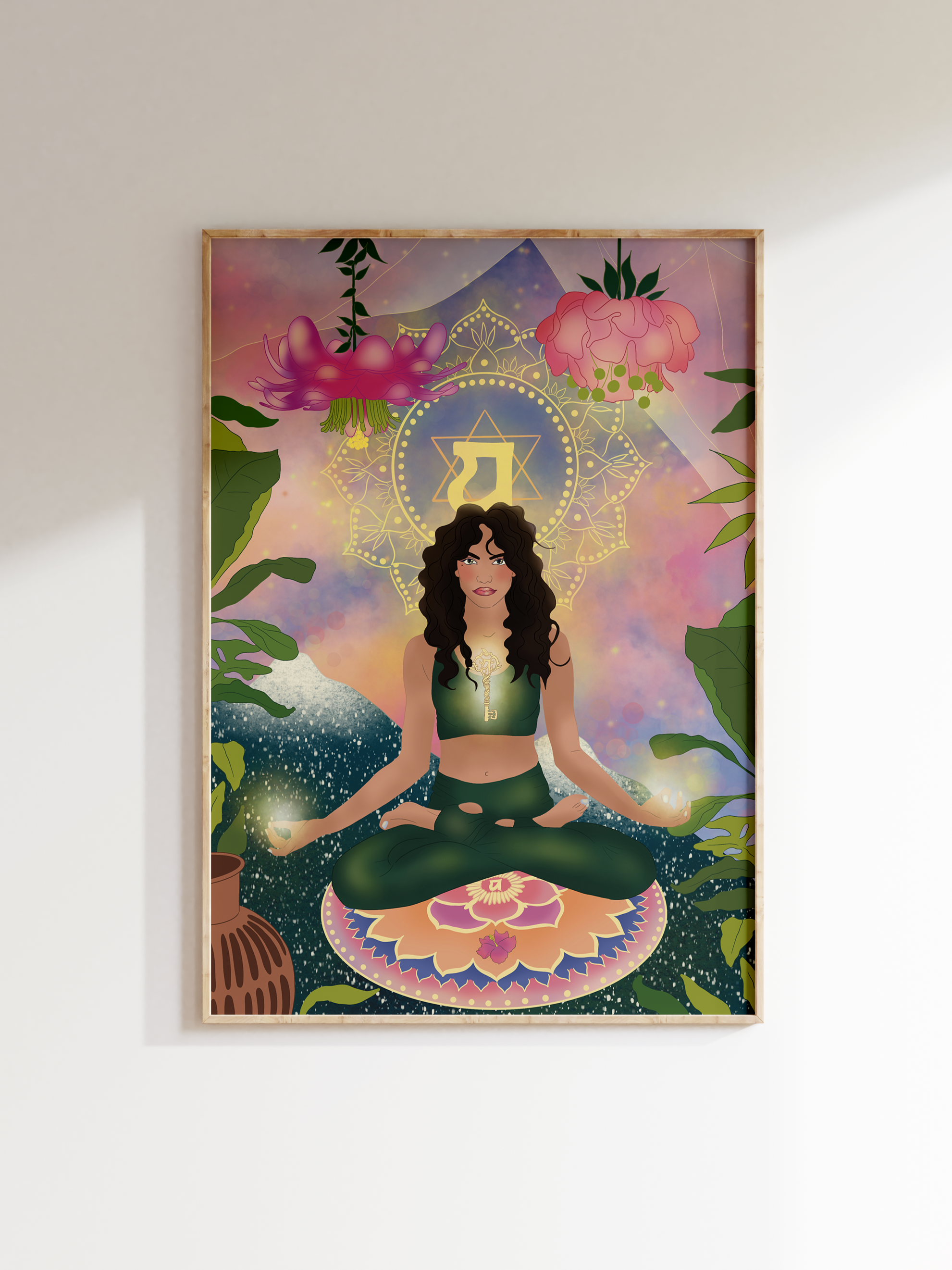 A colorful illustration of a woman with long dark curly hair sitting cross-legged on a pink lotus flower meditation cushion, surrounded by lush green plants, large flowers, and a background with a mountain, sky, and celestial patterns. There is a yellow key hanging from her neck and a decorative mandala and a large Hebrew letter 'Aleph' behind her.