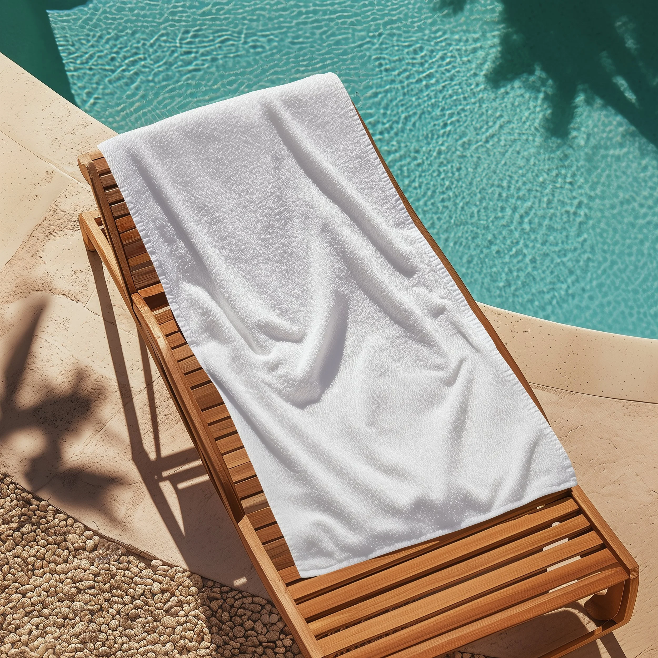 A wooden lounge chair with a white towel draped over it, situated next to a swimming pool with clear water.