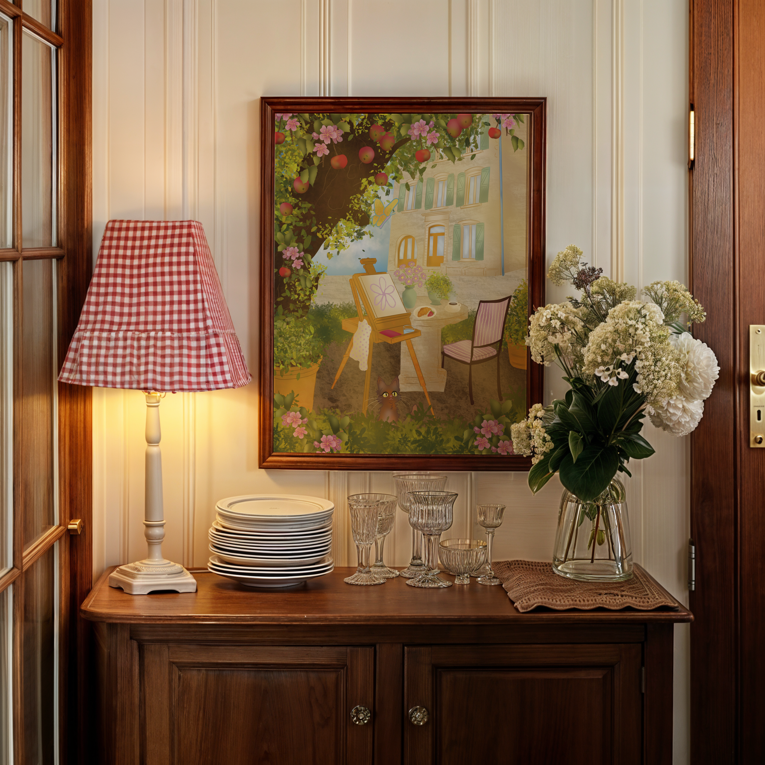 A wooden cabinet with a mirror on top, a red checkered lamp, a stack of white plates, several glassware items, and a bouquet of flowers in a glass vase.