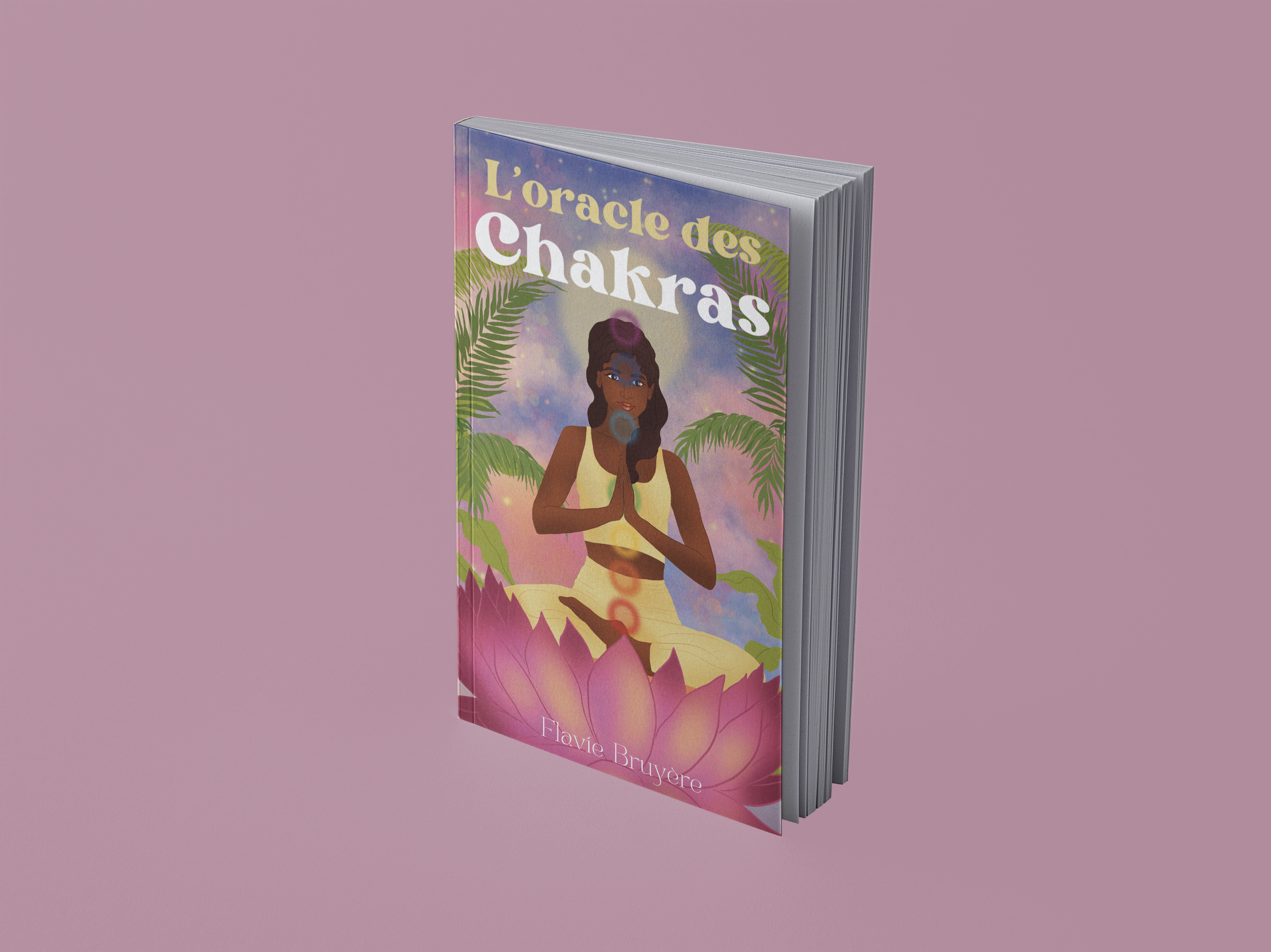 A book titled 'L'oracle des Chakras' with an illustrated cover featuring a woman in a meditative pose, surrounded by colorful background and lotus flower, against a pink background.