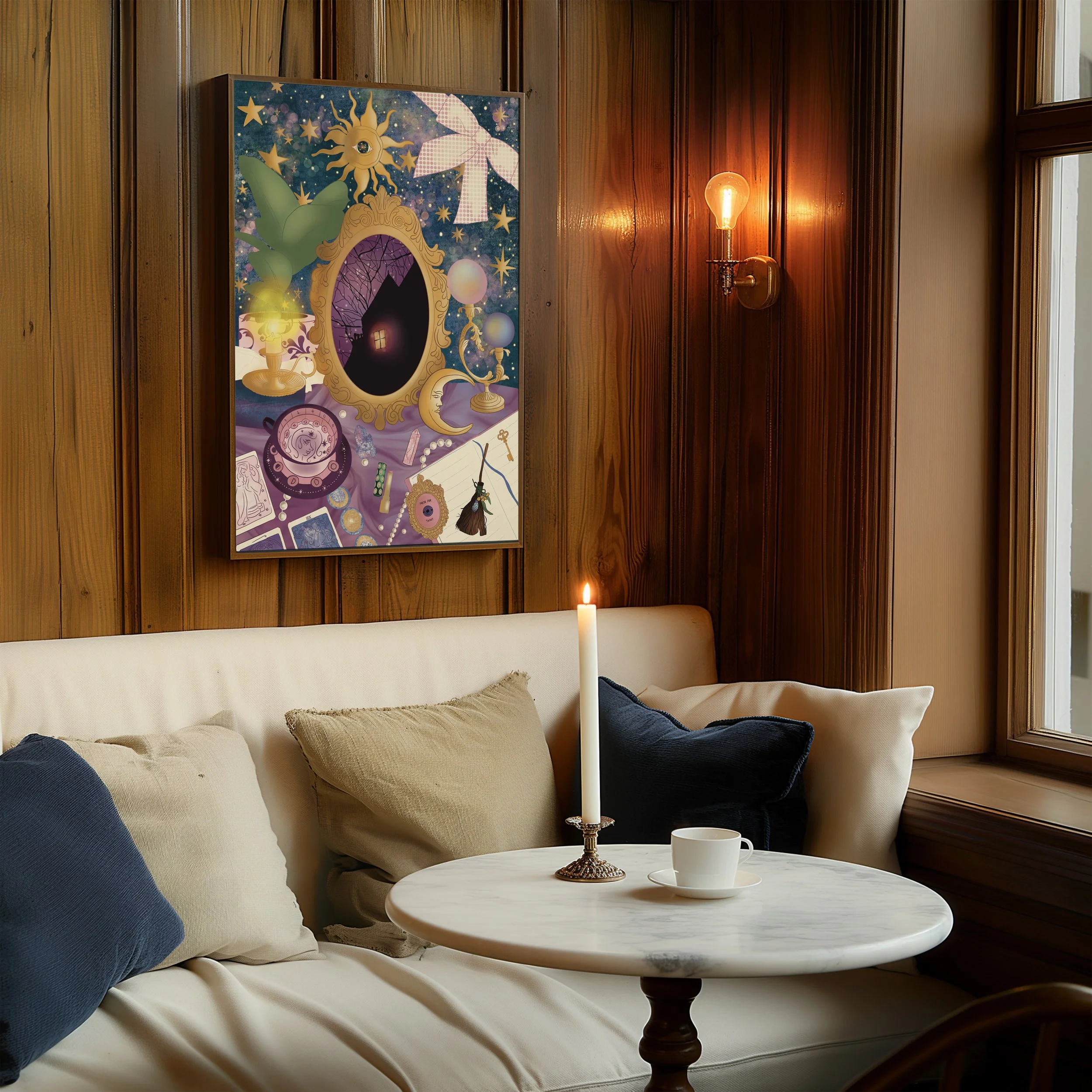 A cozy living room corner with a white sofa, colorful pillows, a round white marble coffee table with a brass candle holder and a lit candle, wooden paneled walls, a painted canvas artwork, a candle on the wall, and a window letting in natural light.