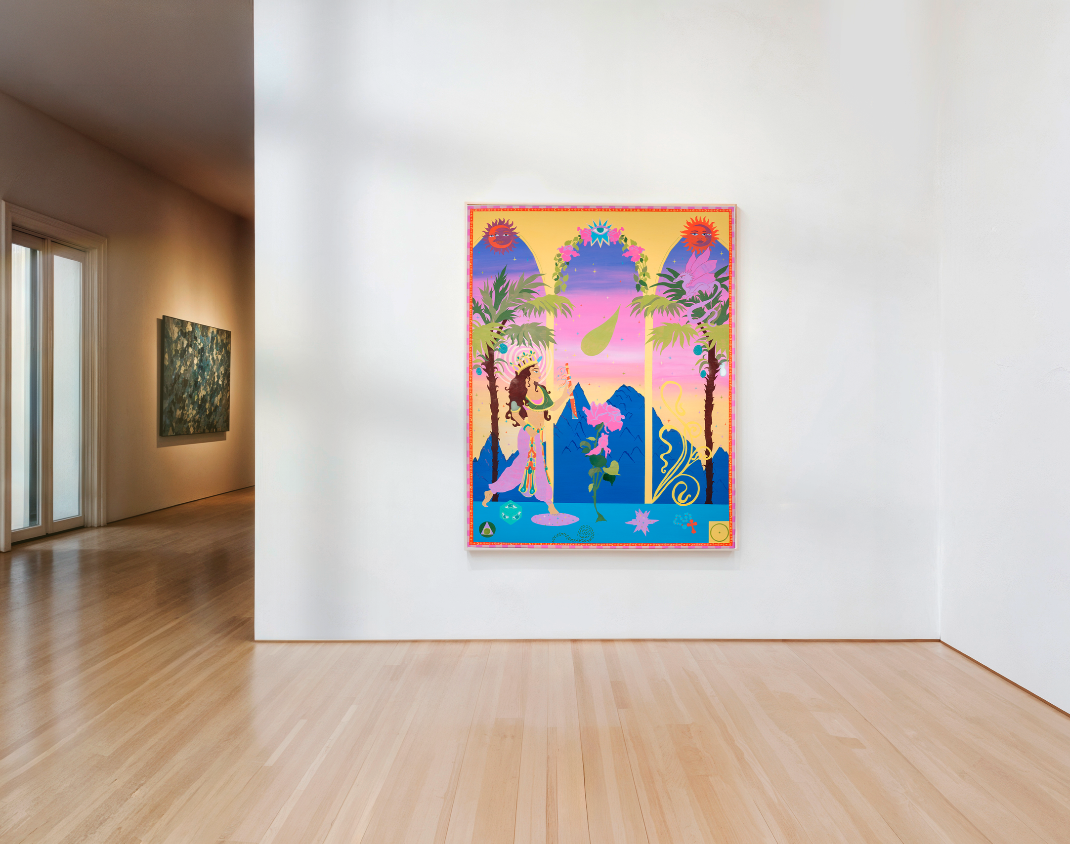Colorful poster with fantasy and nature elements hanging on a white gallery wall in an art exhibit space.