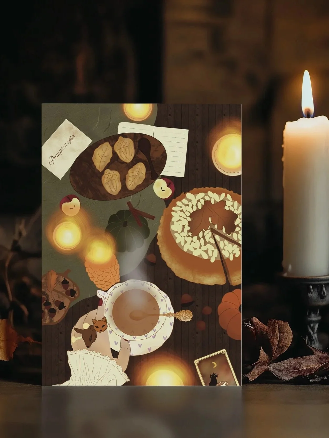 Autumn-themed illustrated table setting with pumpkin pie, cookies, leaves, apples, a cup of tea or coffee, and a candle, surrounded by warm, glowing lights.