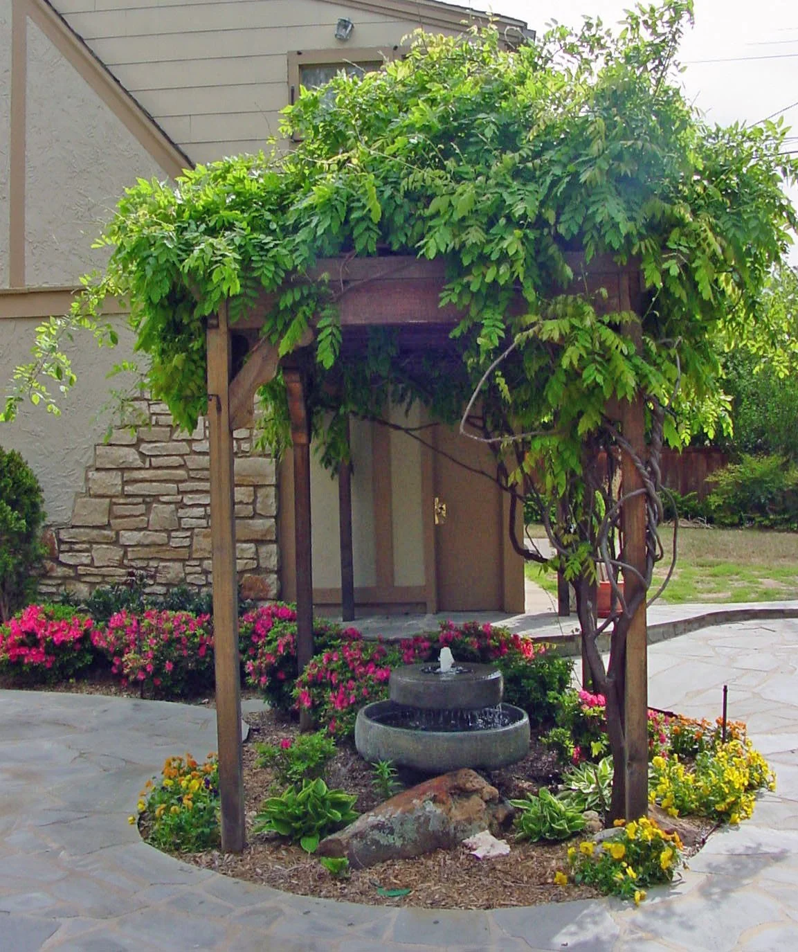 Wood arbor in Tulsa creating a shaded garden entry with climbing plants