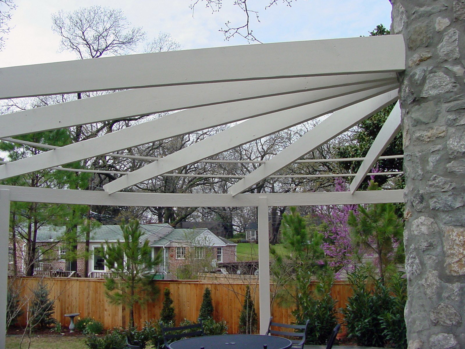 Custom garden arbor in Tulsa with landscape planting and walkway design