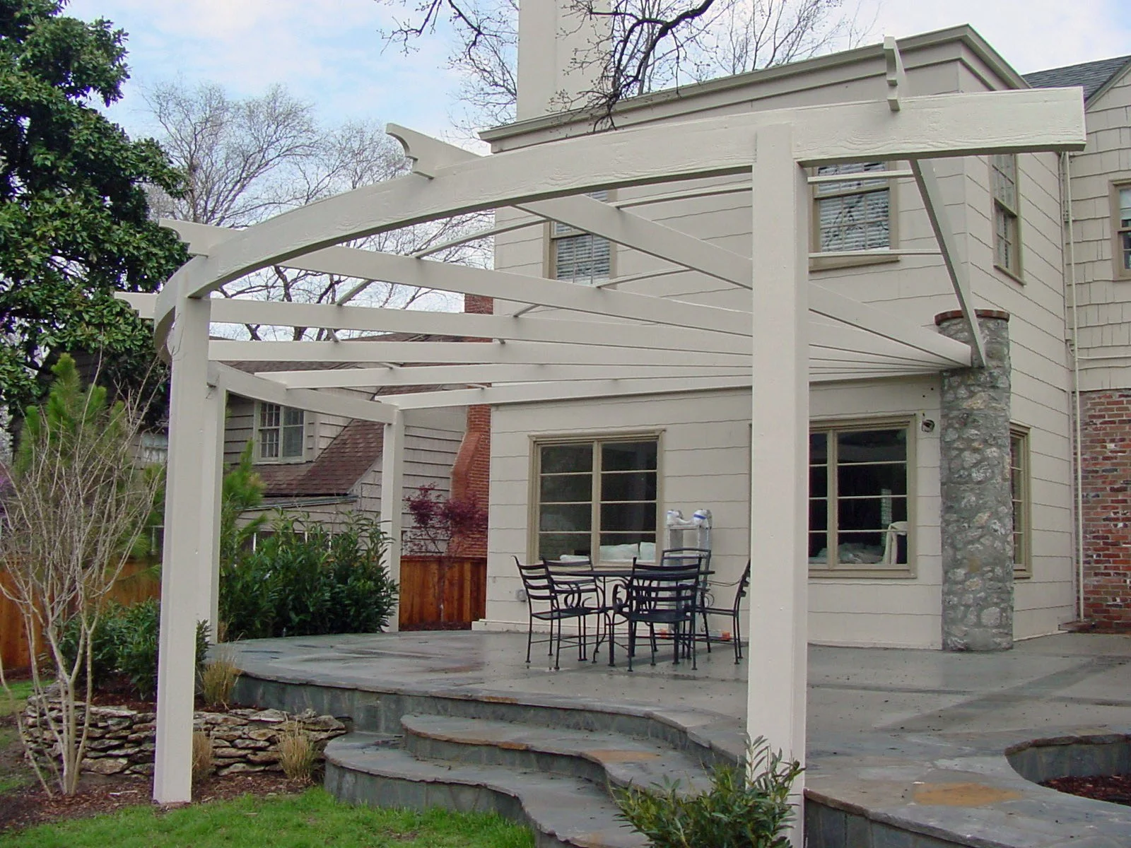Custom garden arbor in Tulsa with landscape planting and walkway design