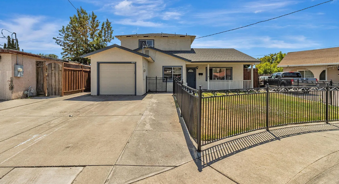 Front exterior of sold home at 10297 Chrisland Court, San Jose CA featuring a two-story house with single-car garage, extended driveway, fenced front yard, and covered porch in a quiet residential neighborhood.