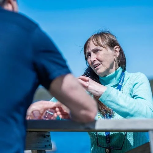 Supportive one-on-one care at Vida Nova Recovery Centre, with a counsellor and guest connecting outdoors in a calm natural setting.
