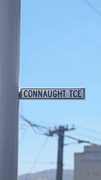 Street sign reading 'CONNAUGHT TCE' against a blue sky background.