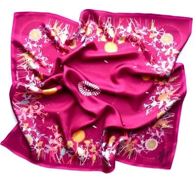 Pink silk scarf with white, yellow, and orange floral and sunburst patterns, draped in a casual style.