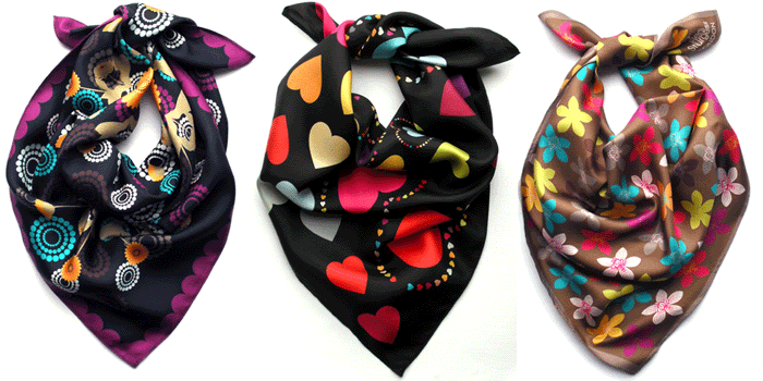 Three colorful scarves with floral and heart patterns, arranged side by side.