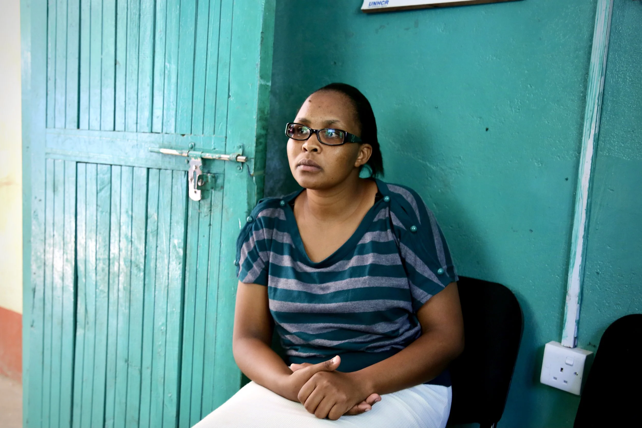 Sarah Chepleting, one of the refugee women helping run the Safe Haven, sits inside the shelter where staff balanced counselling, administration and daily care.