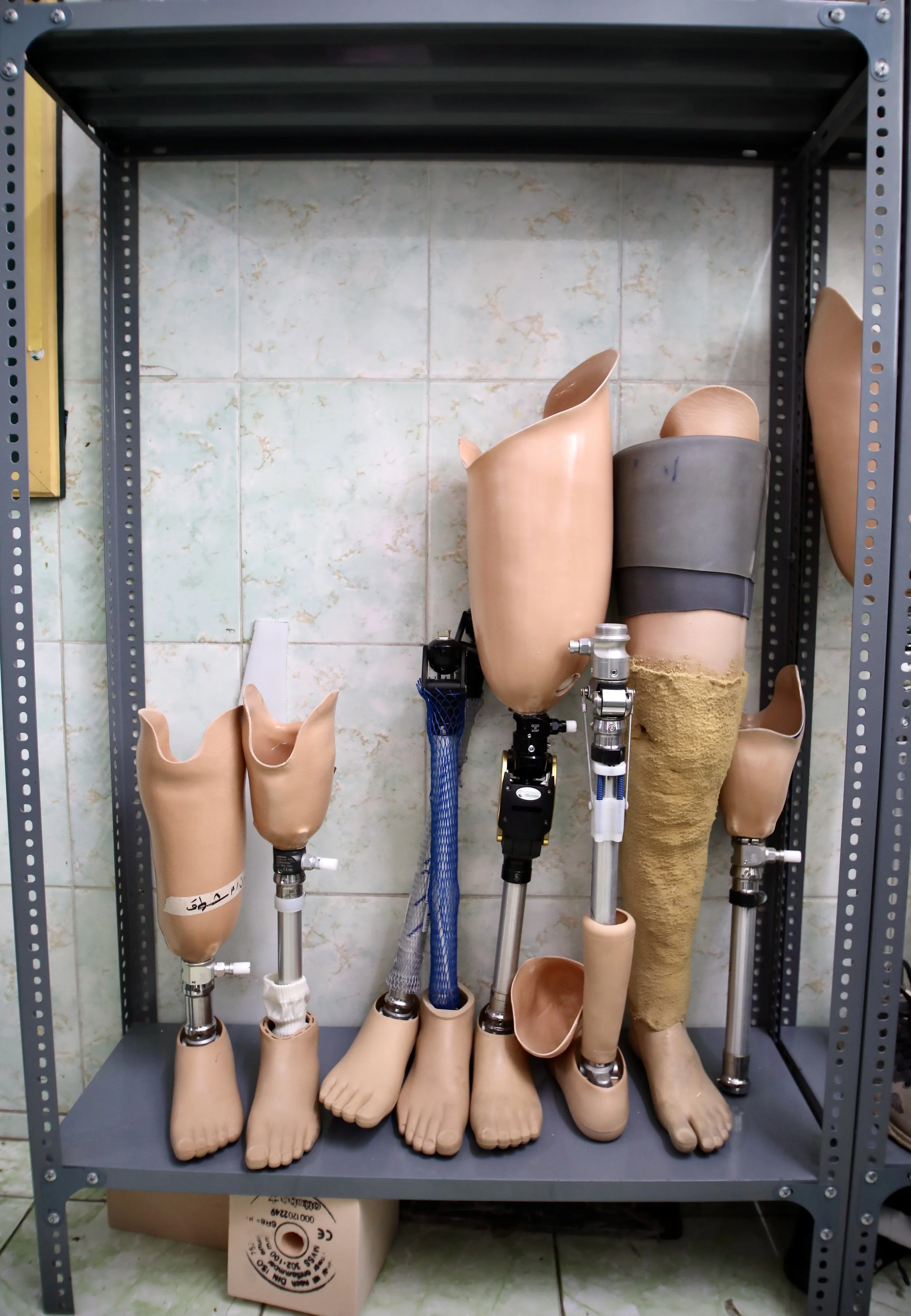 Finished prosthetic limbs stored inside the rehabilitation centre workshop in Aden, Yemen. The youngest patients treated at the centre are five months old.