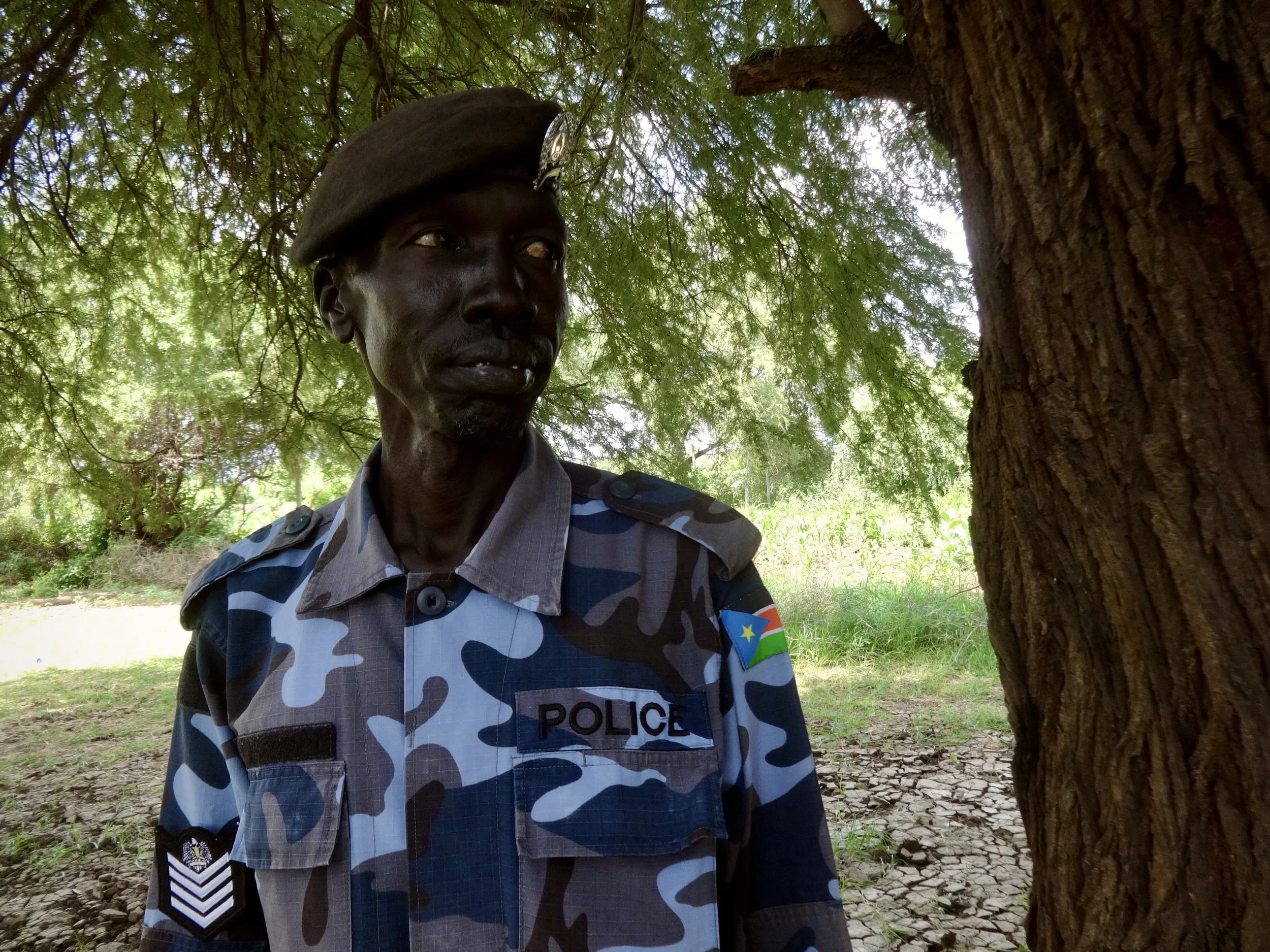 A South Sudanese police officer stands near the border. Local authorities on both sides were involved in managing the flow of asylum seekers.