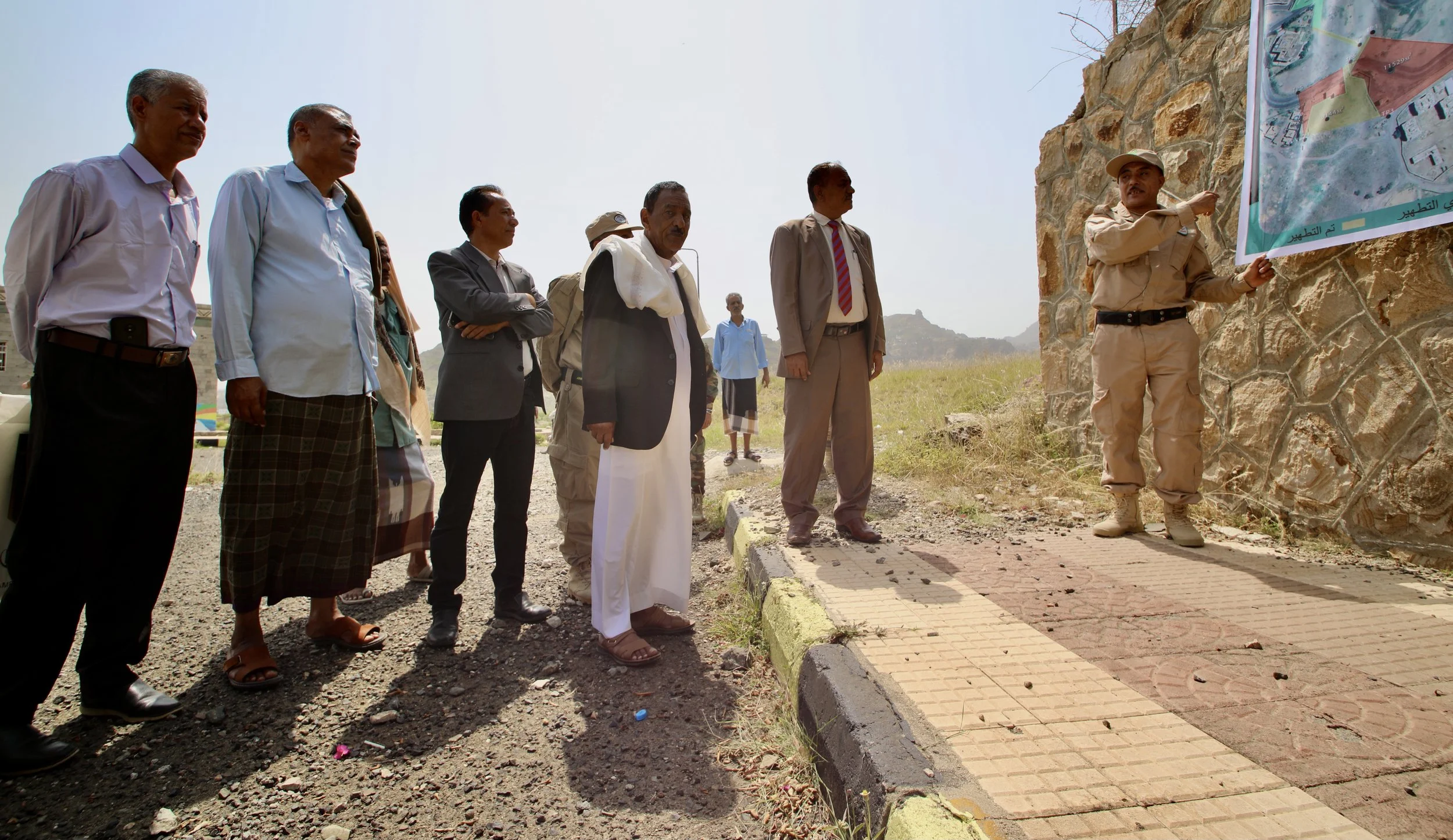 Local sheikhs and education officials receive a briefing by Colonel Aref Al-Qahtani, Supervisor of Project Masam demining teams across Taiz Governorate, before an Explosive Ordnance Risk Education (EORE) session in western Taiz, Yemen. Community awar