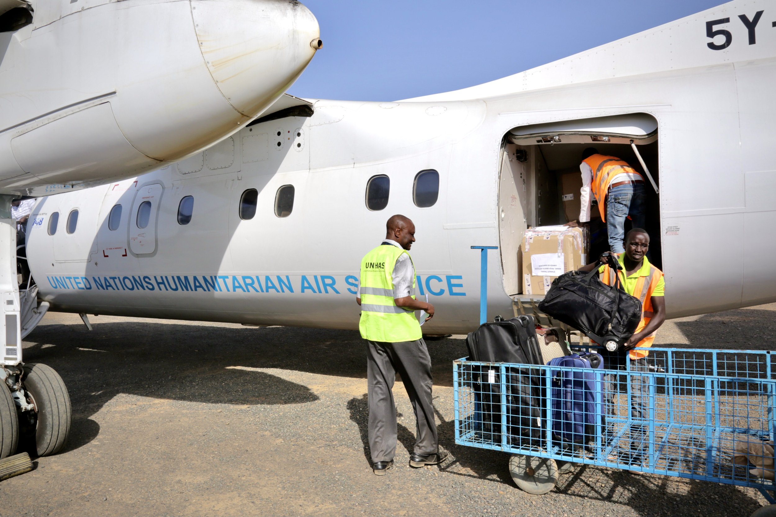 Ground staff load luggage onto a UN-chartered flight carrying refugees out of Kakuma. For Marie Angel, the journey marked the end of years of uncertainty and the beginning of a new life elsewhere.