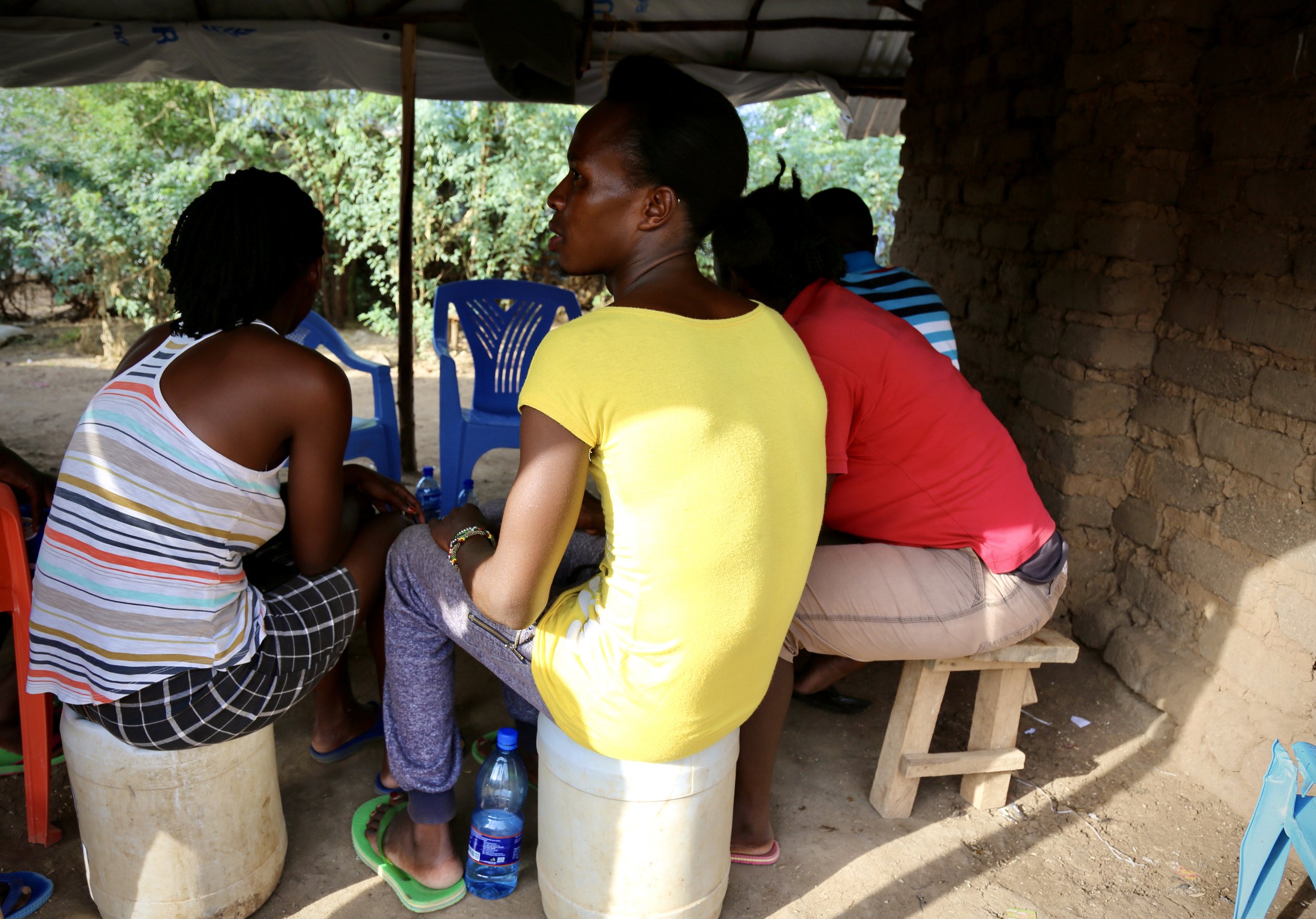 Residents sit together during a meeting inside a shelter in Kakuma refugee camp, where many LGBTQ+ refugees said isolation and insecurity shaped daily life.