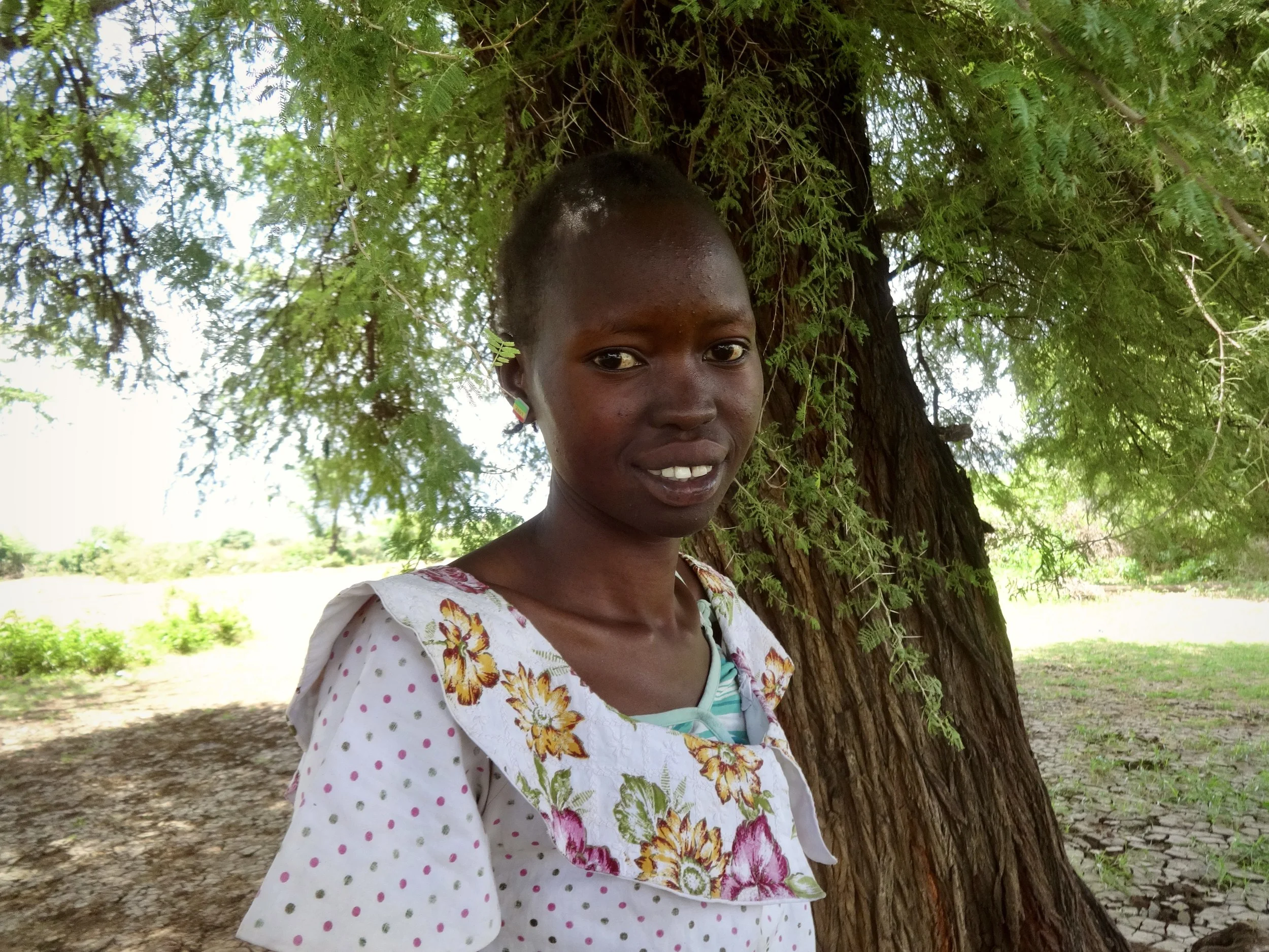 Randa, a 24-year-old South Sudanese woman, waits near the border after being refused entry into Kenya.