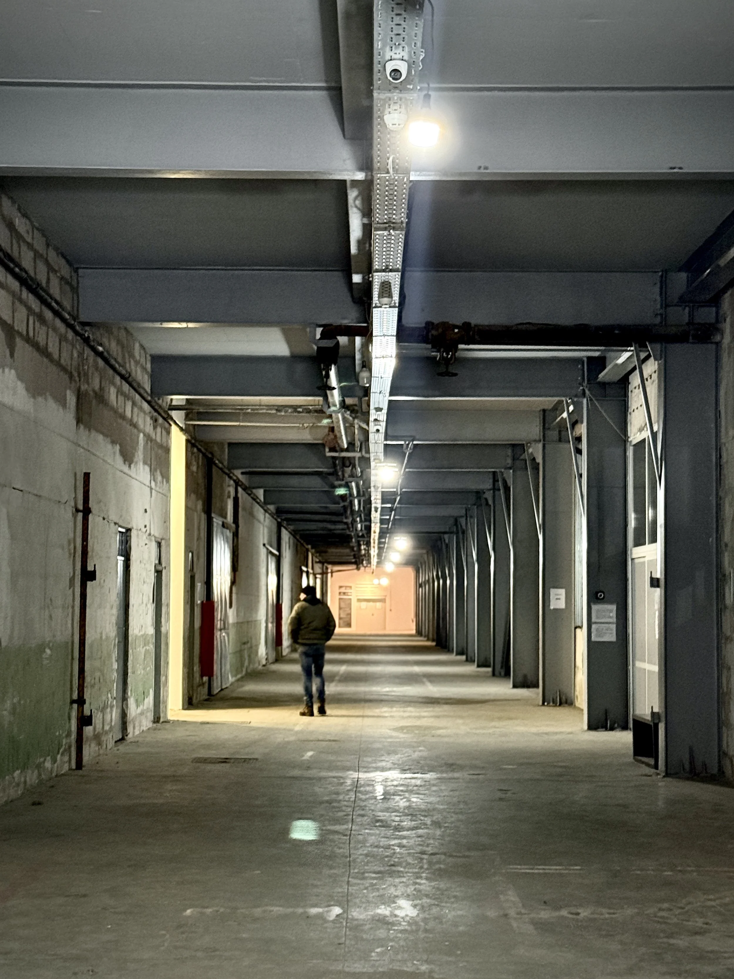Inside the former factory halls used by Dutch UN peacekeepers. In July 1995, more than 20,000 displaced Bosniaks gathered nearby hoping the UN presence would offer protection; many were later separated, forced onto buses or killed.
