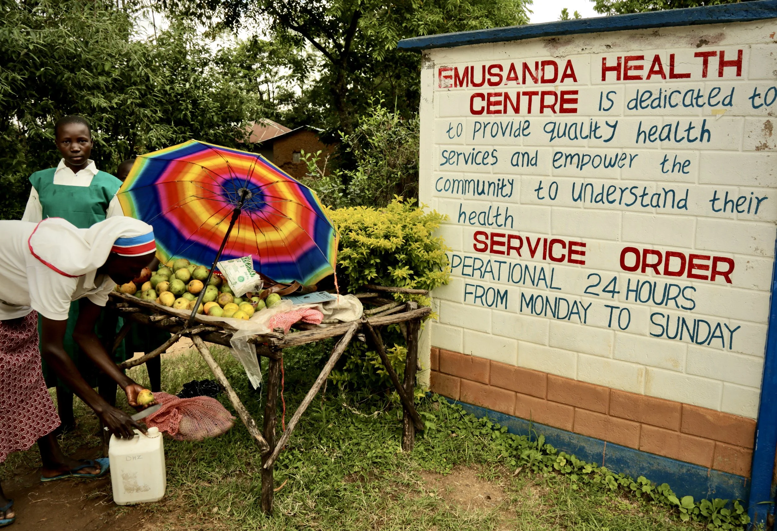 A nurse washes fruit with clean water outside Emusanda Health Centre. Health workers say access to safe water remains fundamental to hygiene and disease prevention in the community.