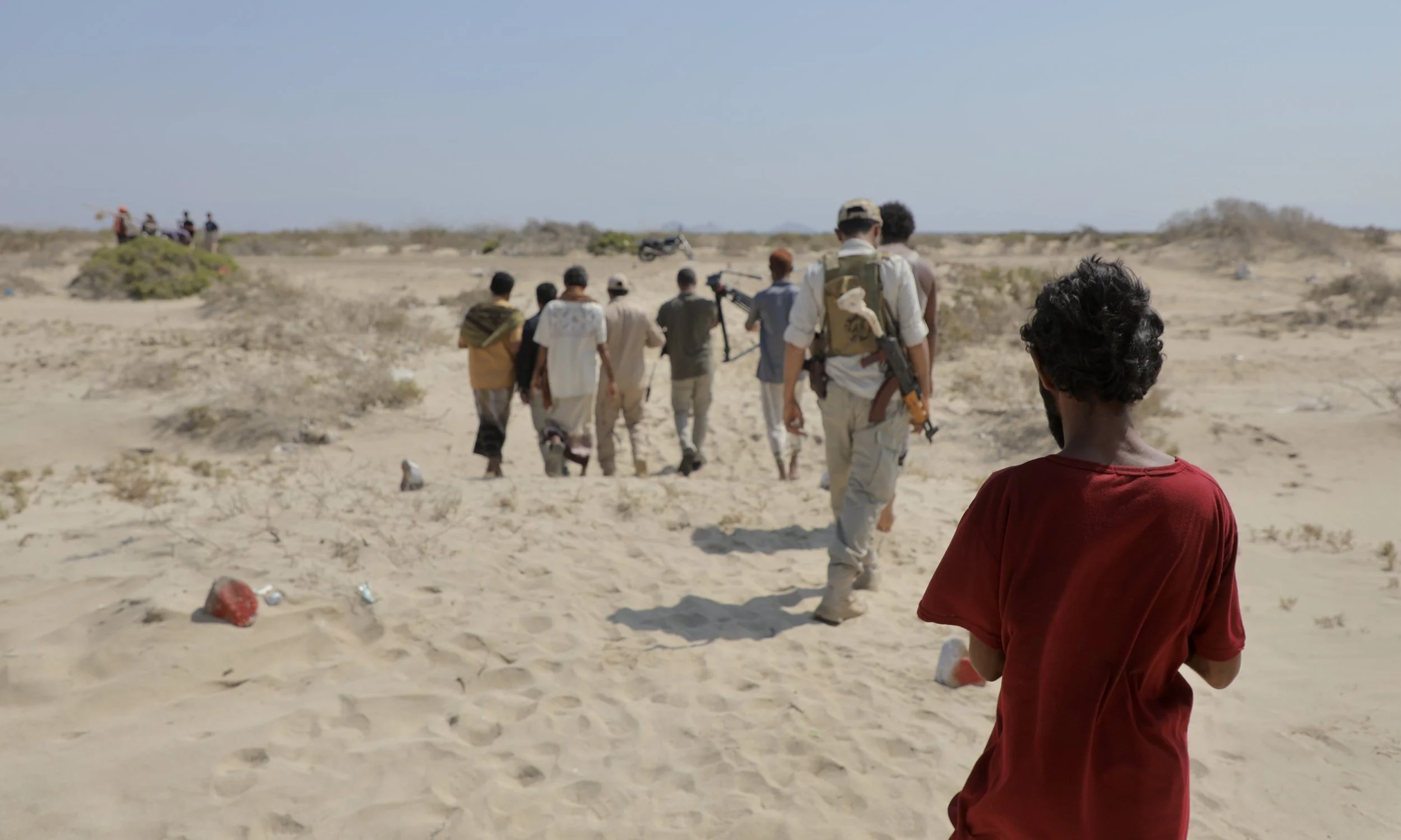 Deminers and local residents walk toward a hazardous coastal area north of Al Khokha, near Yemen’s frontline with Houthi forces. The western coastline remains among the country’s most heavily contaminated regions after years of conflict.