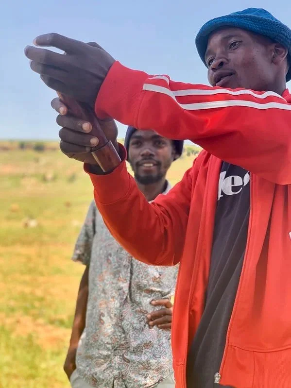 Peer educator P., a former herd boy, leads a discussion with herd boys during an HIV and STI prevention session in Leribe district.