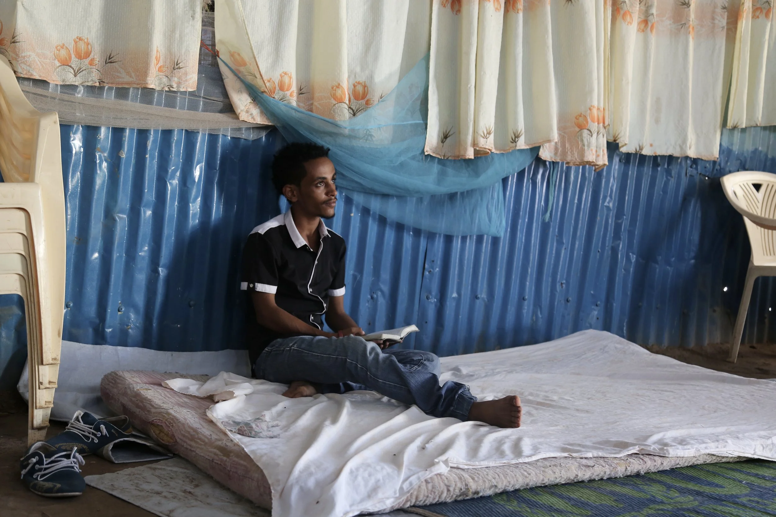Nazrit reads in the room he shared with family members. He said the pressure was on him to gain an education and transform their circumstances.