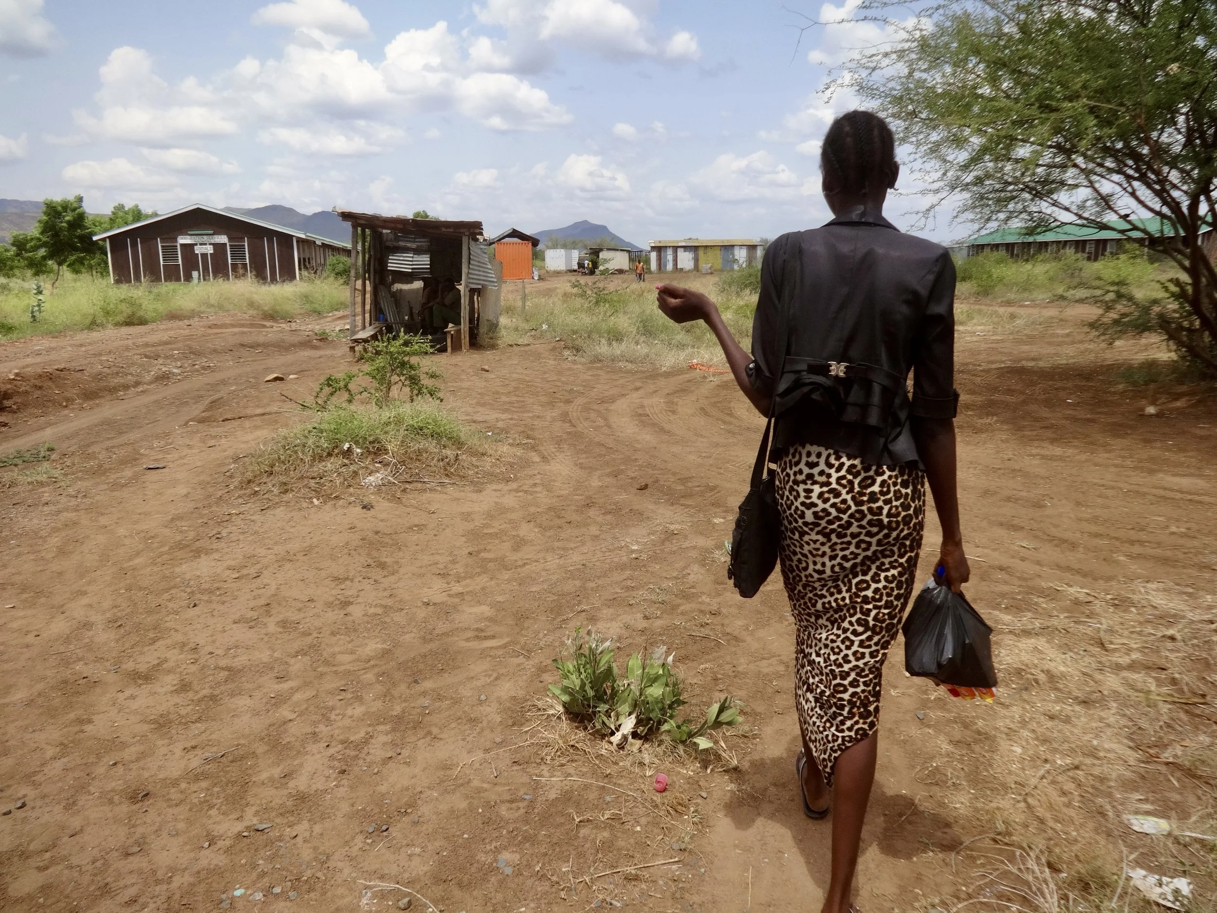 Randa walks along the road near the border, uncertain how long she will remain stranded.