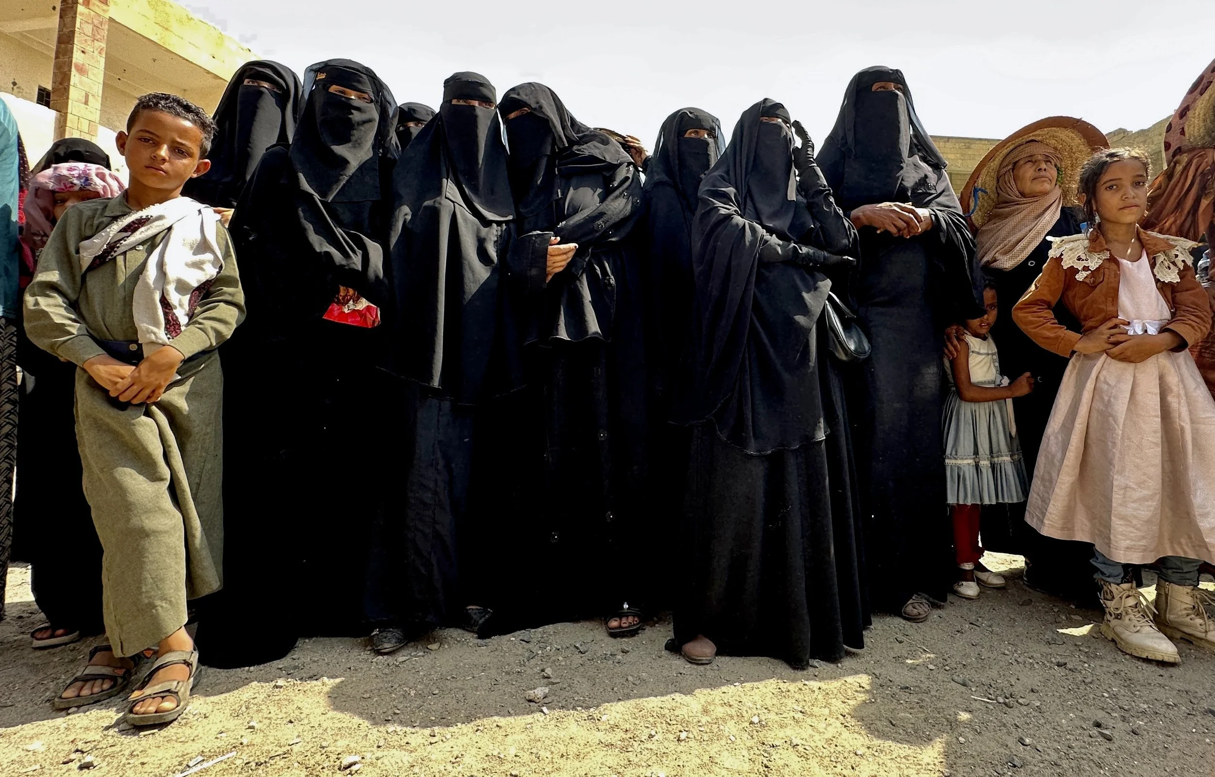 Women and children gather during an Explosive Ordnance Risk Education session in Sabr Almawadim, western Taiz, Yemen. Gender-sensitive awareness campaigns increasingly target mothers and children, who are among the civilians most vulnerable to explos