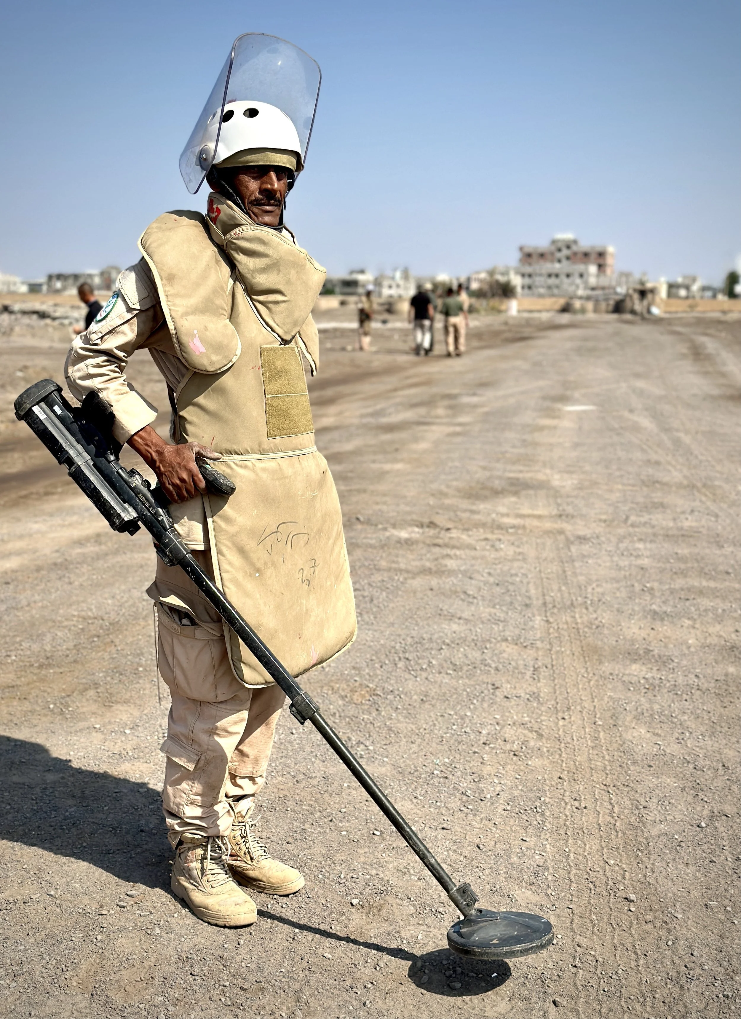 Project Masam deminer Mohammed Qassim Naji advances across cleared lanes with a detector at Aden International Airport. Teams move metre by metre through former conflict ground to locate hidden explosives before land can be safely reused.