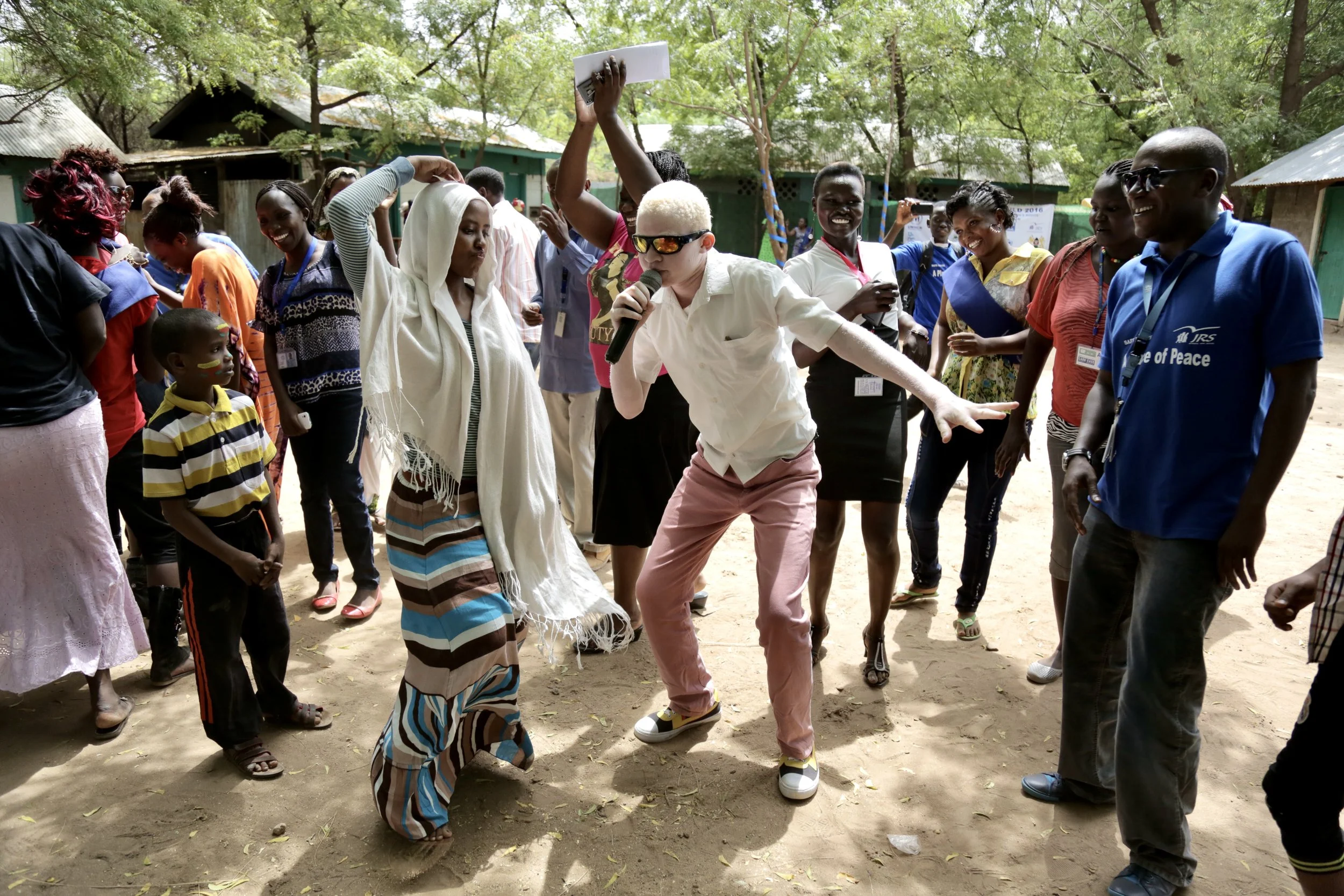 Evariste raps, and dances with other young refugees during a gathering inside the compound. Music offered release from the pressures of camp life.