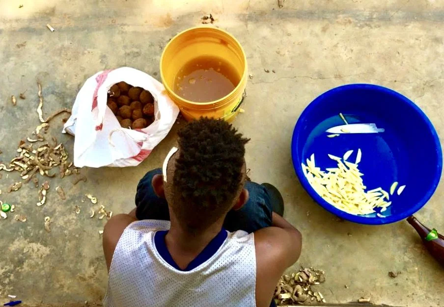 Venuste Maronko prepares potatoes for lunch inside the Kigali compound where Burundian refugees shared cooking, cleaning and other daily responsibilities. Having fled Burundi before completing his studies in cinema and the arts, Maronko moved between