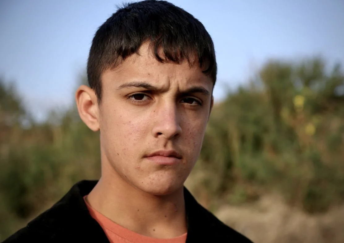 Portrait of Hamed, 15, an Afghan refugee living among other unaccompanied minors in the Calais camp. 