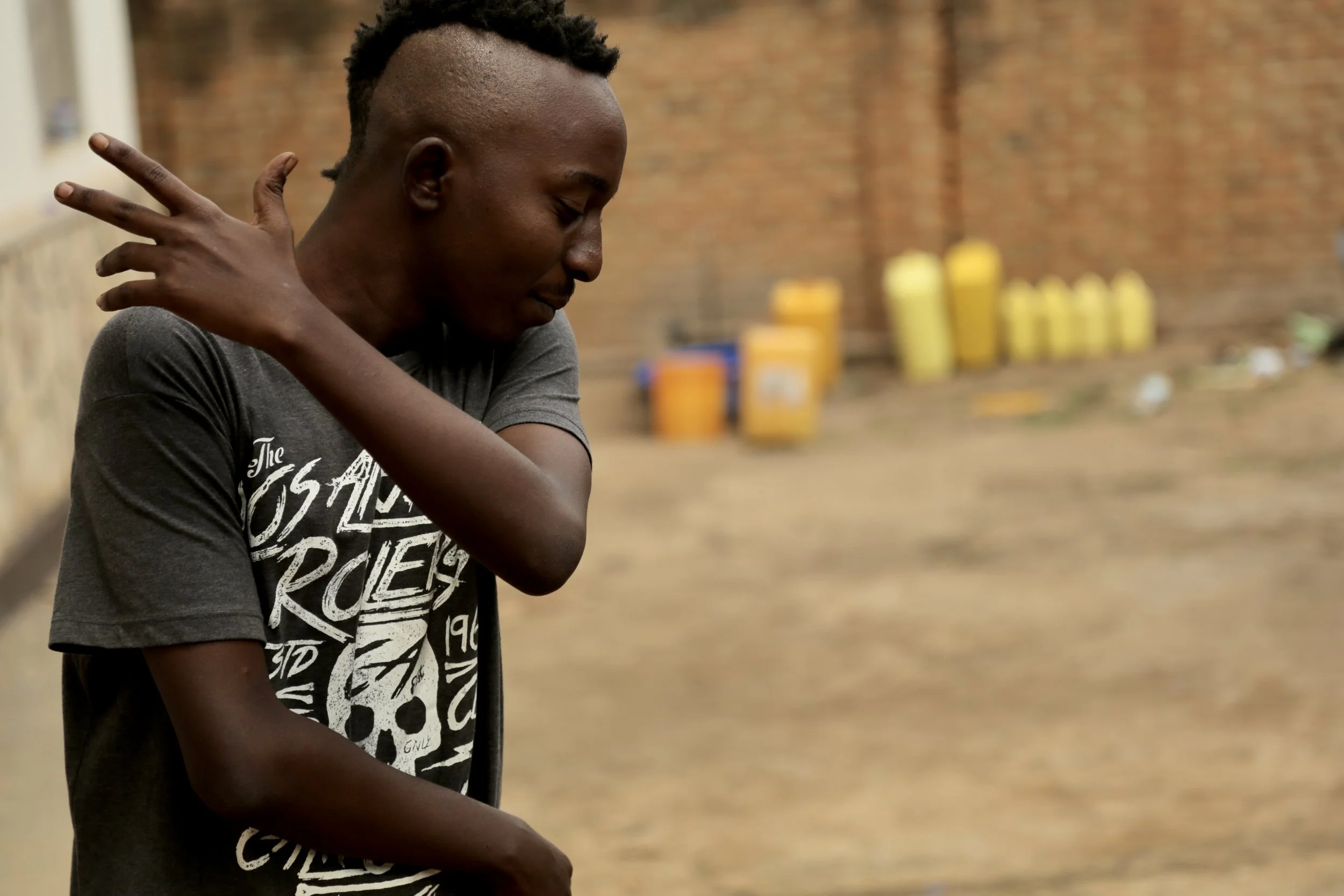 Venuste Maronko dances in the courtyard of the Kigali compound to Niko Sawa by popular Burundian artist Big Fizzo, played from a mobile phone. Music was a constant presence inside the house, where young Burundian refugees used dance, film, photograph