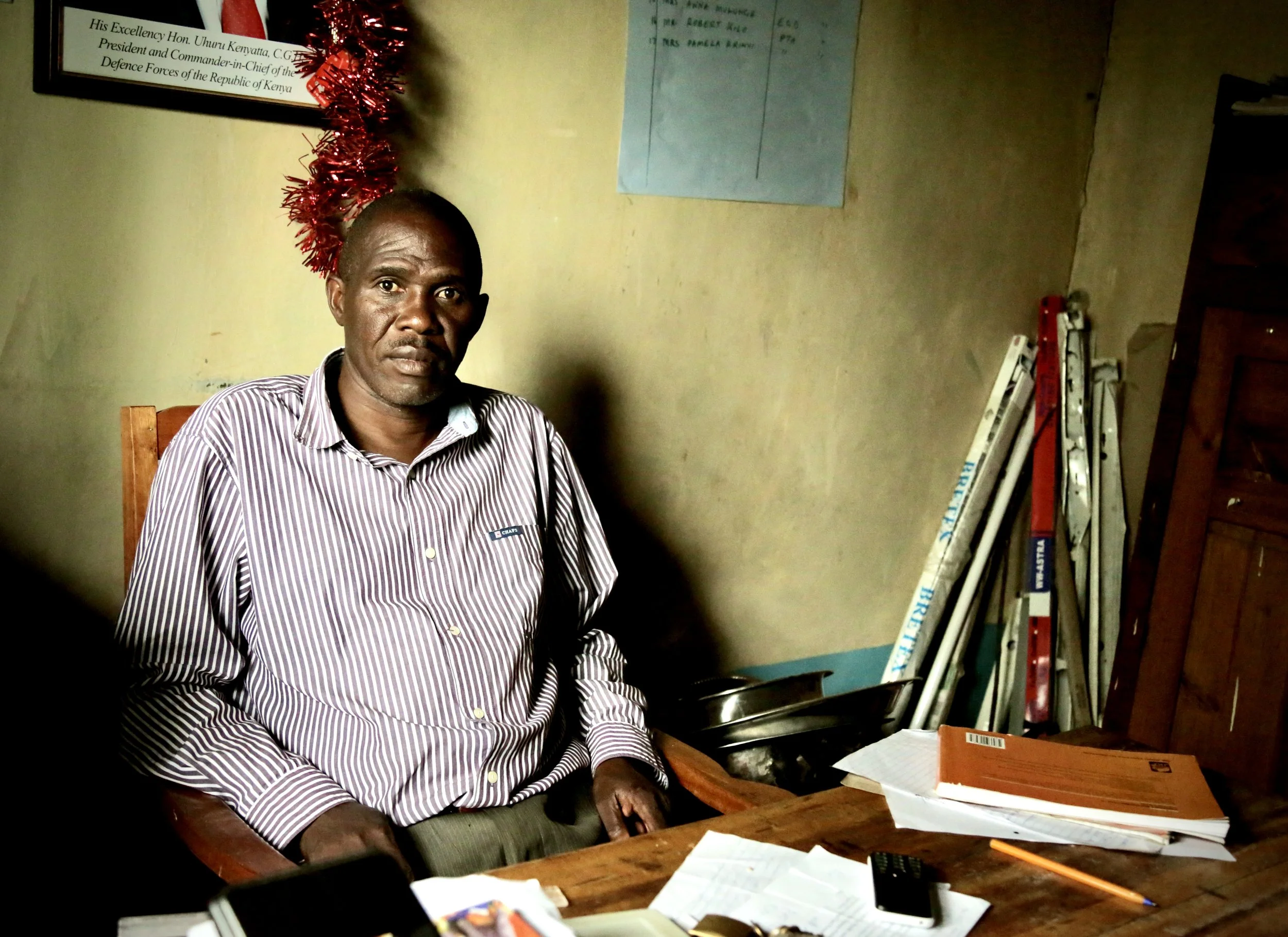 Saidi Olacho, Head Teacher at Albertos Divine Providence School, sits in his office in Kakamega County. Olacho oversees a school where access to water affects everything from meal preparation and cleaning to the amount of time pupils spend studying o