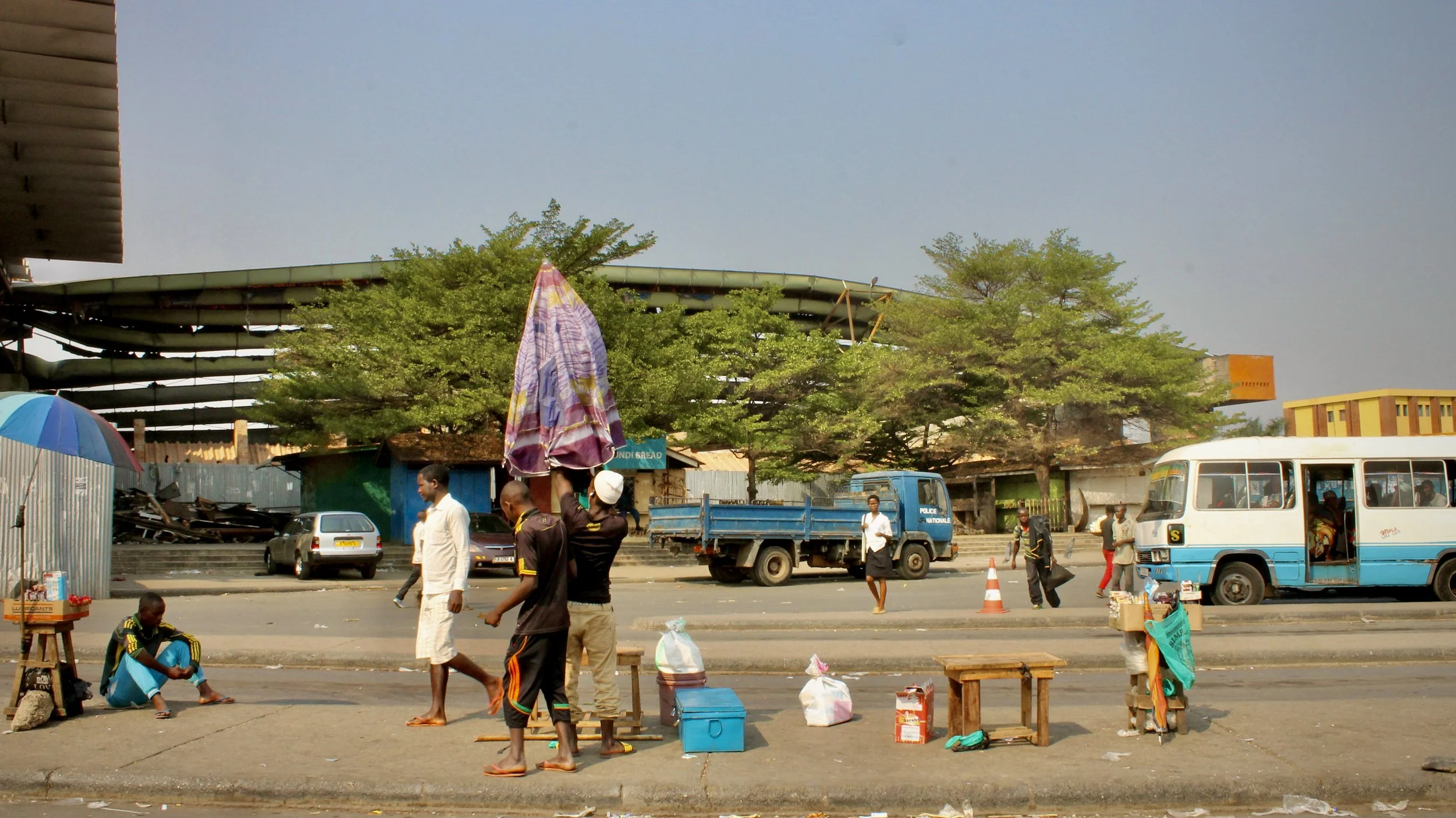 Traders and pedestrians move through a market area in Bujumbura. Once known as "Buja la Belle" for its lively atmosphere and thriving economy, many residents described a city transformed by fear, uncertainty and declining incomes.