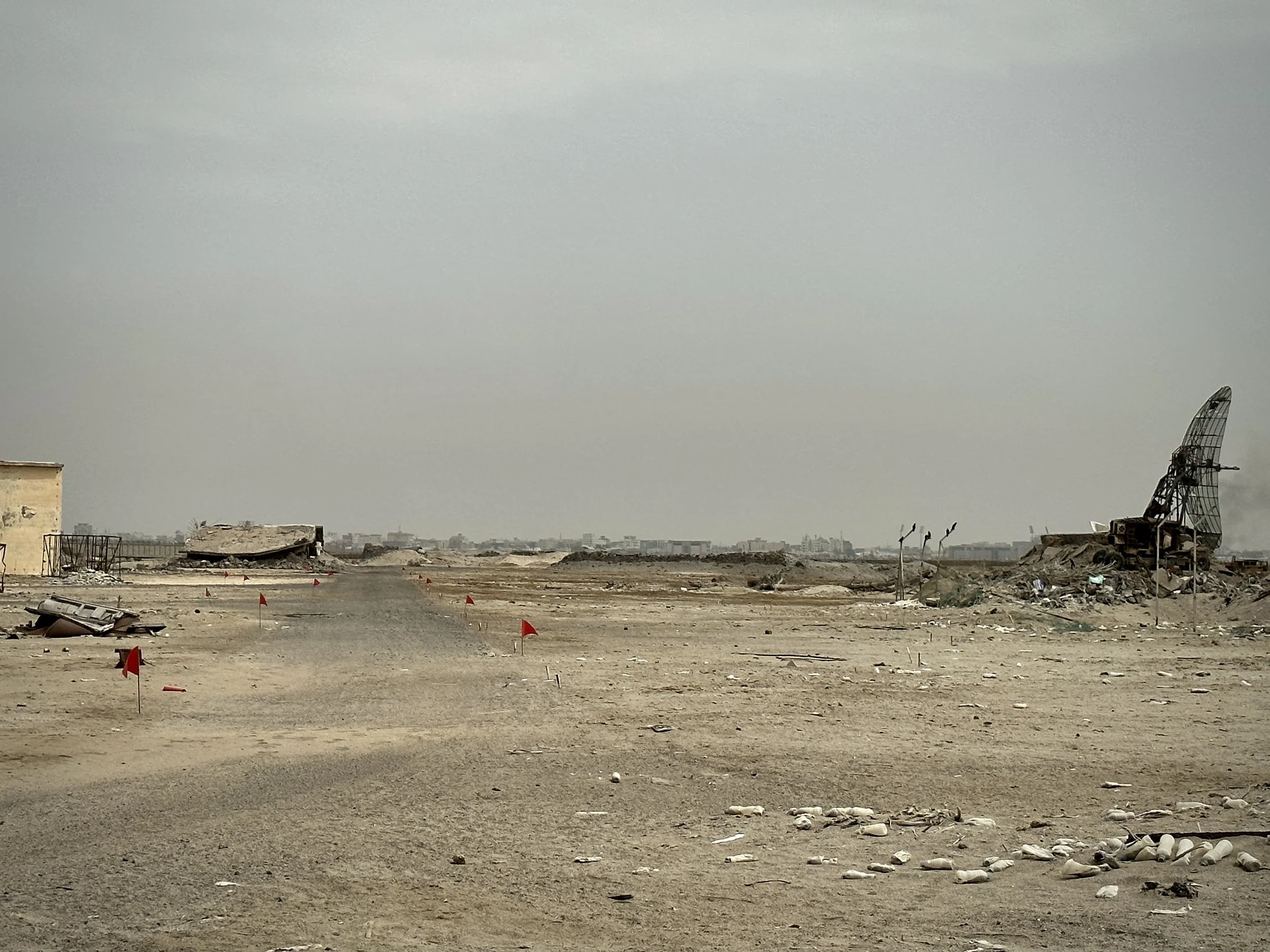 A wide stretch of damaged open ground inside Aden International Airport awaits continued clearance and redevelopment. Deminers say large exposed areas can still conceal explosive hazards beneath sand, rubble and compacted soil.