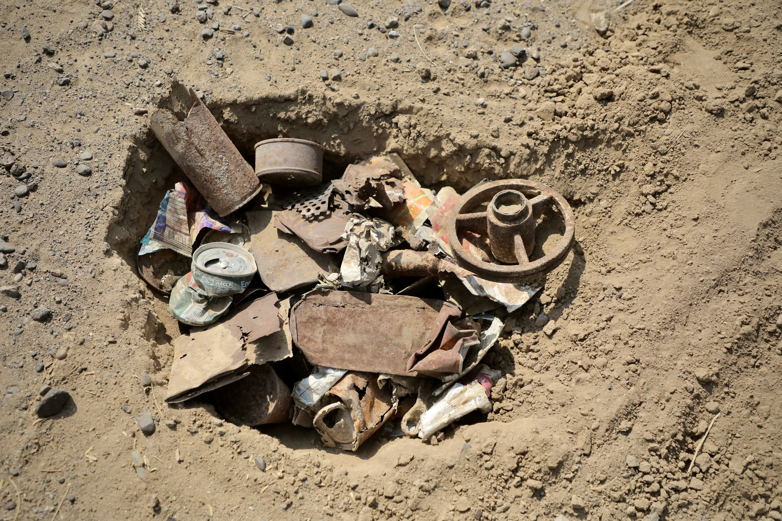 Collected metal fragments and debris are placed in a designated pit away from the clearance area in Al Remah, near Mocha, Taiz governorate, Yemen, to prevent detectors from responding to non-hazardous metal during operations.