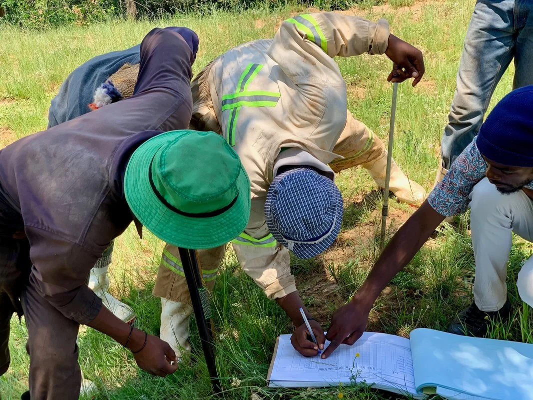 Herd boys sign an attendance register after an HIV and STI prevention session in Leribe district, helping outreach workers track participation in community health activities.